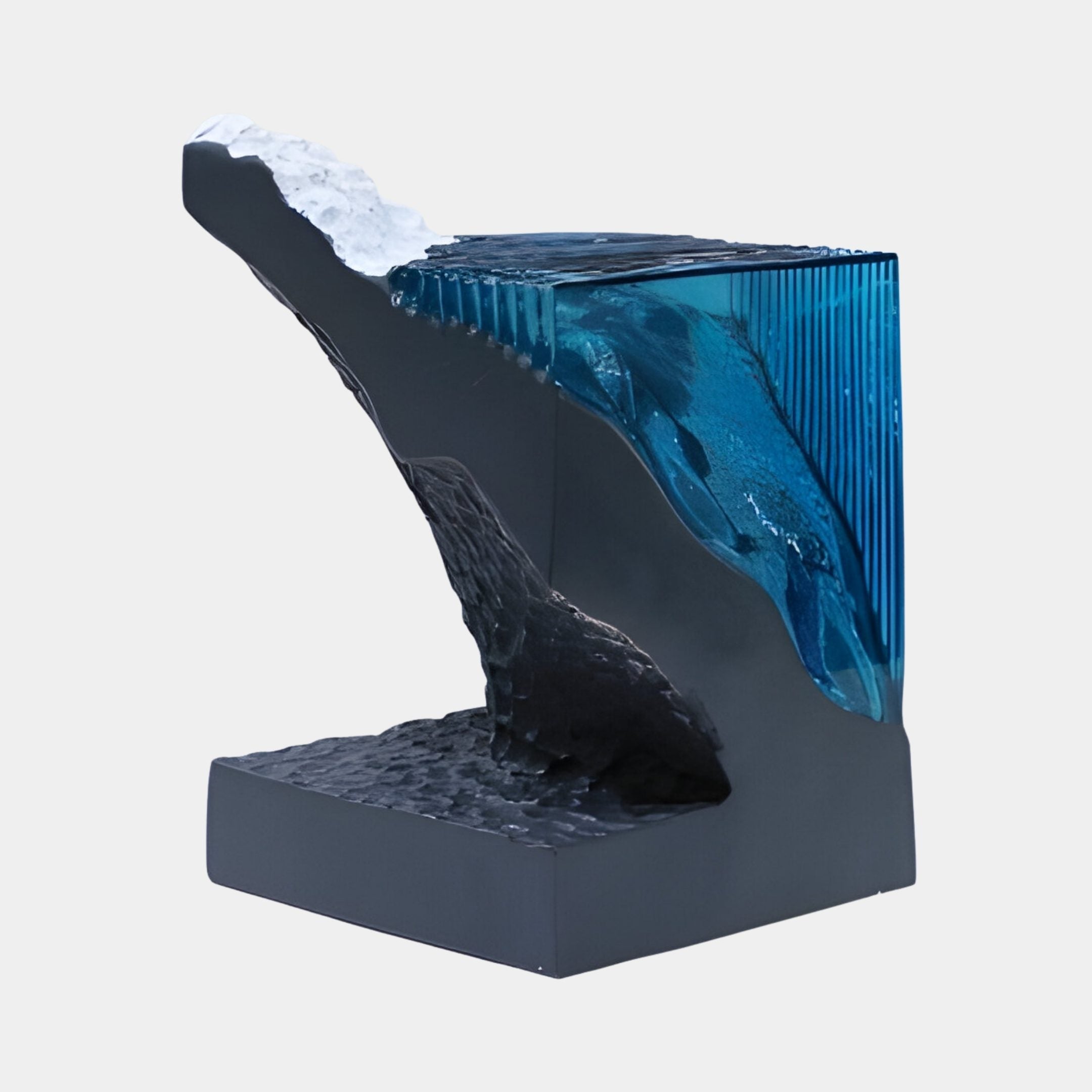 Giant Sculptures Blue Rippled Sea Grey Column 55cm resin sculpture with a translucent blue wave and white foam cresting over a grey stone column.