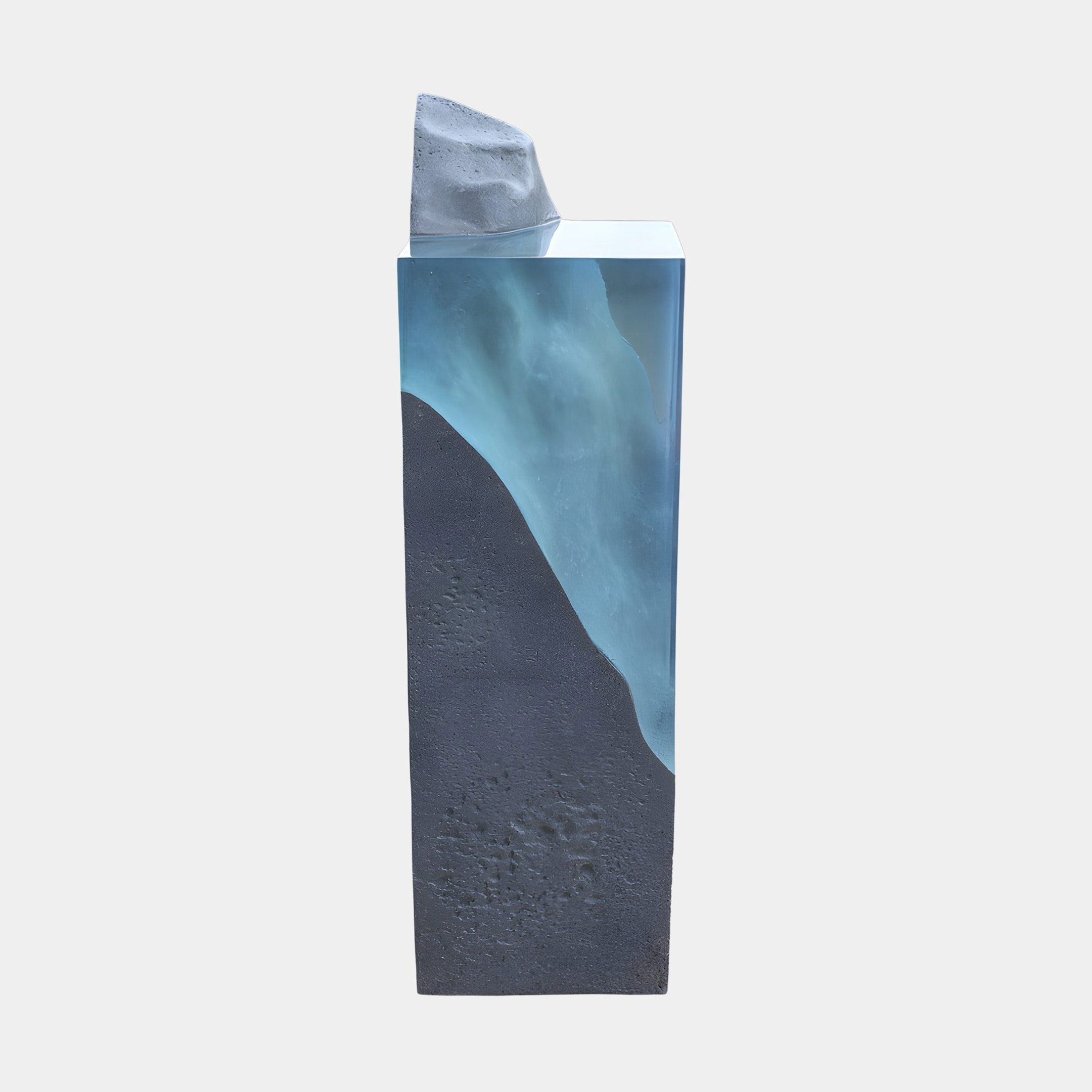 Giant Sculptures Teal Resin Glacial Column with White Peak Sculpture 135cm, showing a teal resin wave between a grey stone base and white peak, on white.