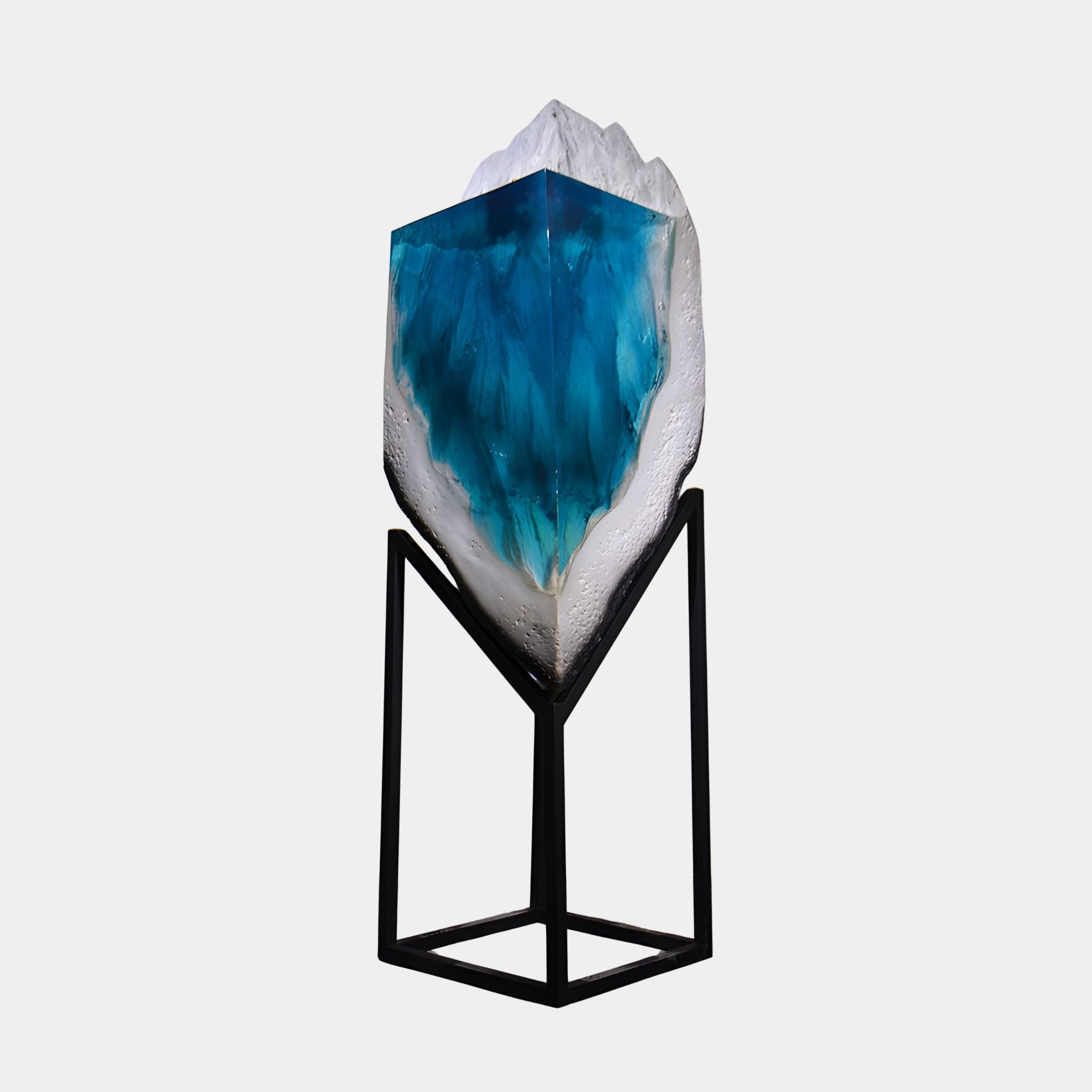 Blue Glacial Flow White Crag resin sculpture by Giant Sculptures, with turquoise core and white peak on a slim black metal stand, shown against a plain background.
