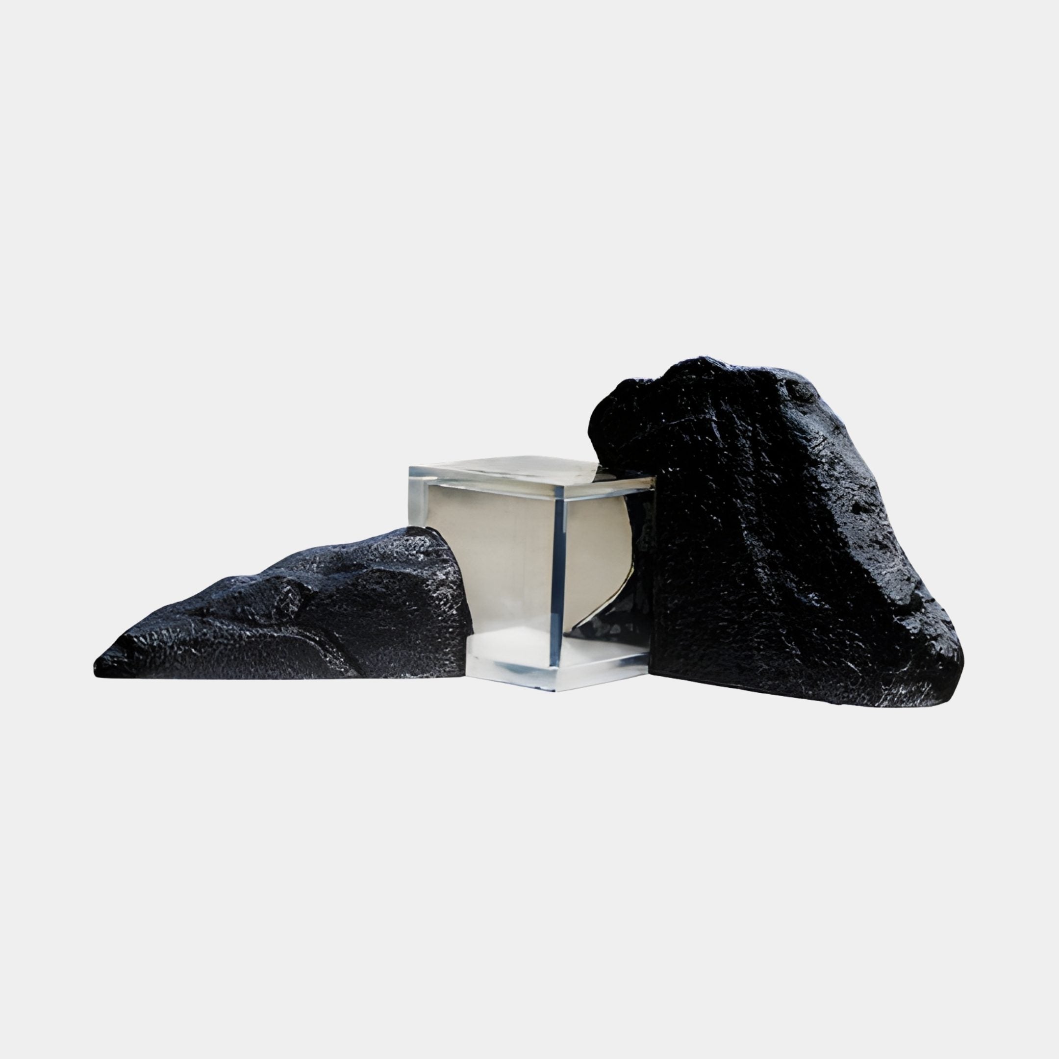 Black Rock Fragment with Clear Resin Sculpture by Giant Sculptures, featuring two textured dark stone pieces flanking a transparent resin block on a plain background.