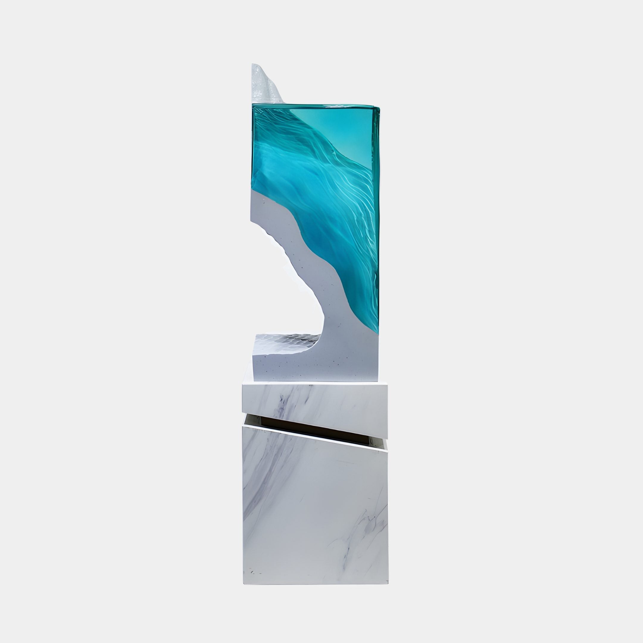 Side view of the Teal Tidal Flow Resin Sculpture by Giant Sculptures, showing the translucent turquoise wave cresting over a white marble column base.