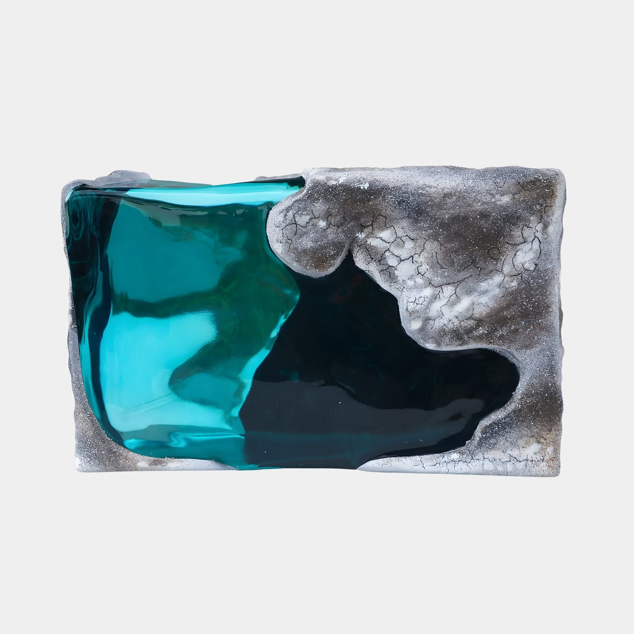 Deep Teal Coastal Tide Pool Stone Resin Sculpture by Giant Sculptures, with glassy turquoise resin pooled in a rugged grey stone form on a white background.