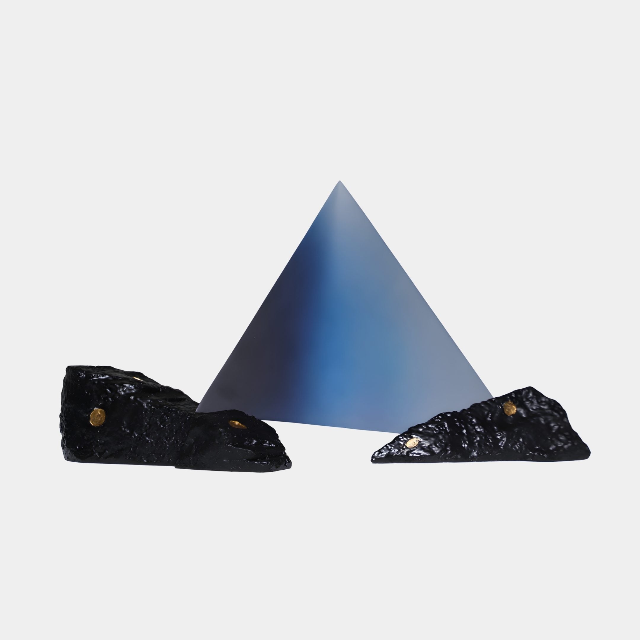 Blue Gradient Pyramid with Rock Resin Sculpture 55cm by Giant Sculptures, smooth pyramid flanked by two gold-flecked black rocks on a plain background.