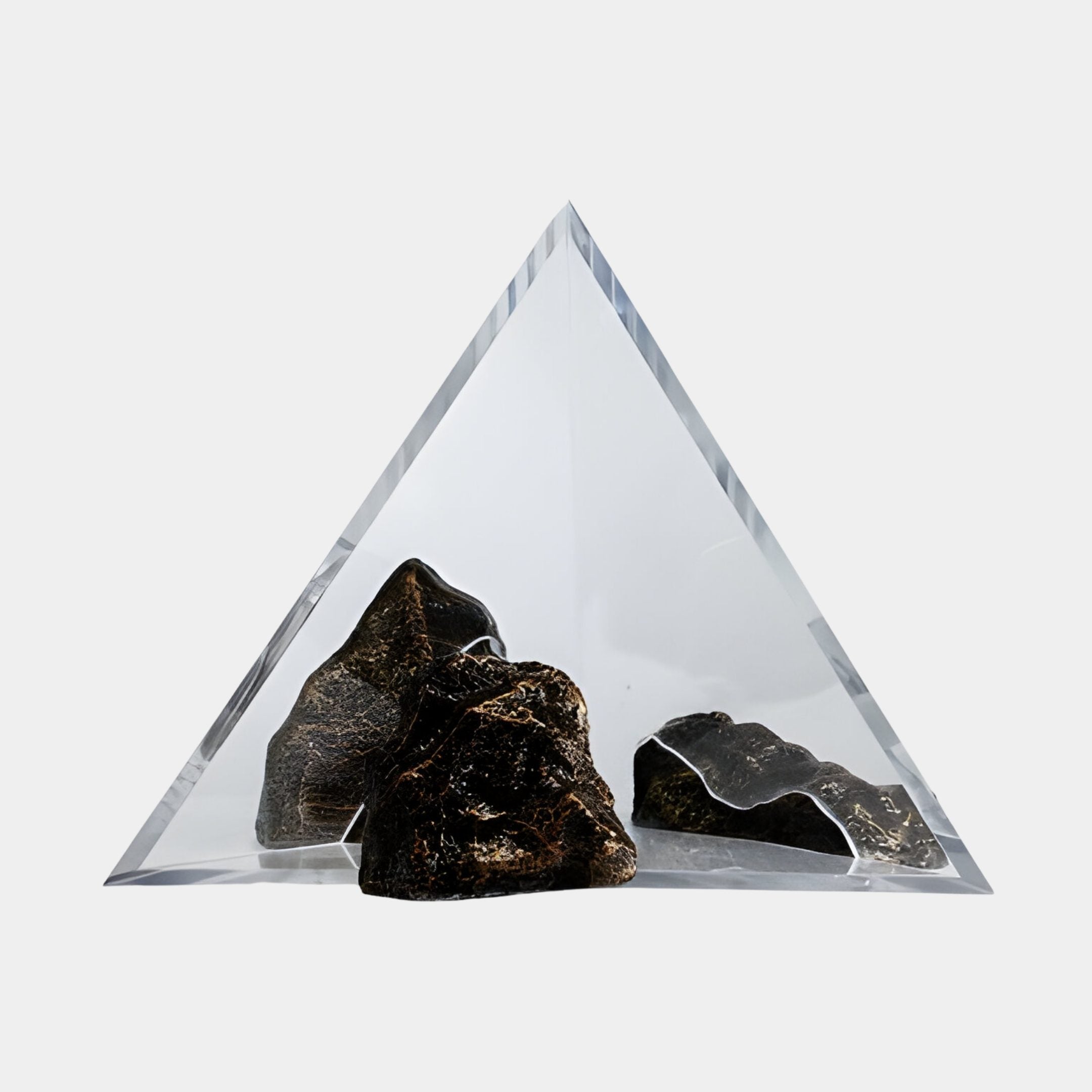 Giant Sculptures Black Rock & Triangle Frame Clear Resin Sculpture 60cm, with dark gold-flecked stones encased beneath a clear pyramid, on a plain background.
