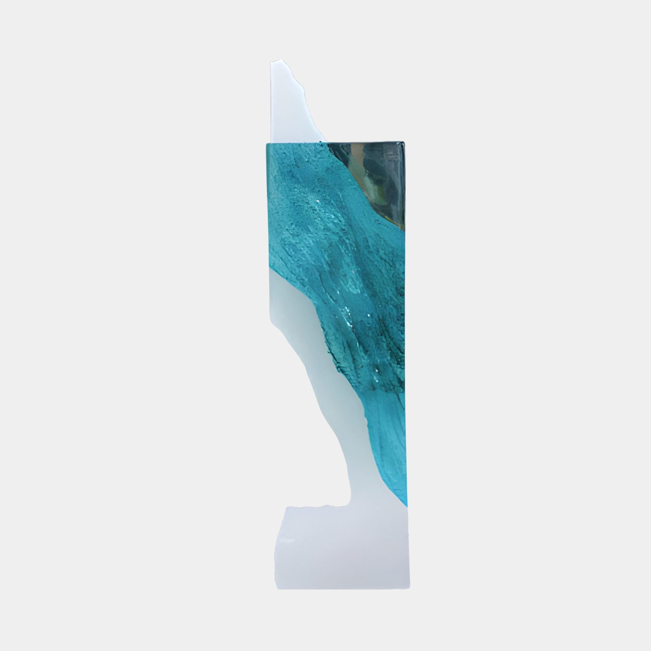 Side view of the Giant Sculptures Teal Blue Clear Glacial Pillar Resin Sculpture, 143cm, showing its slim teal and clear resin profile on a plain background.