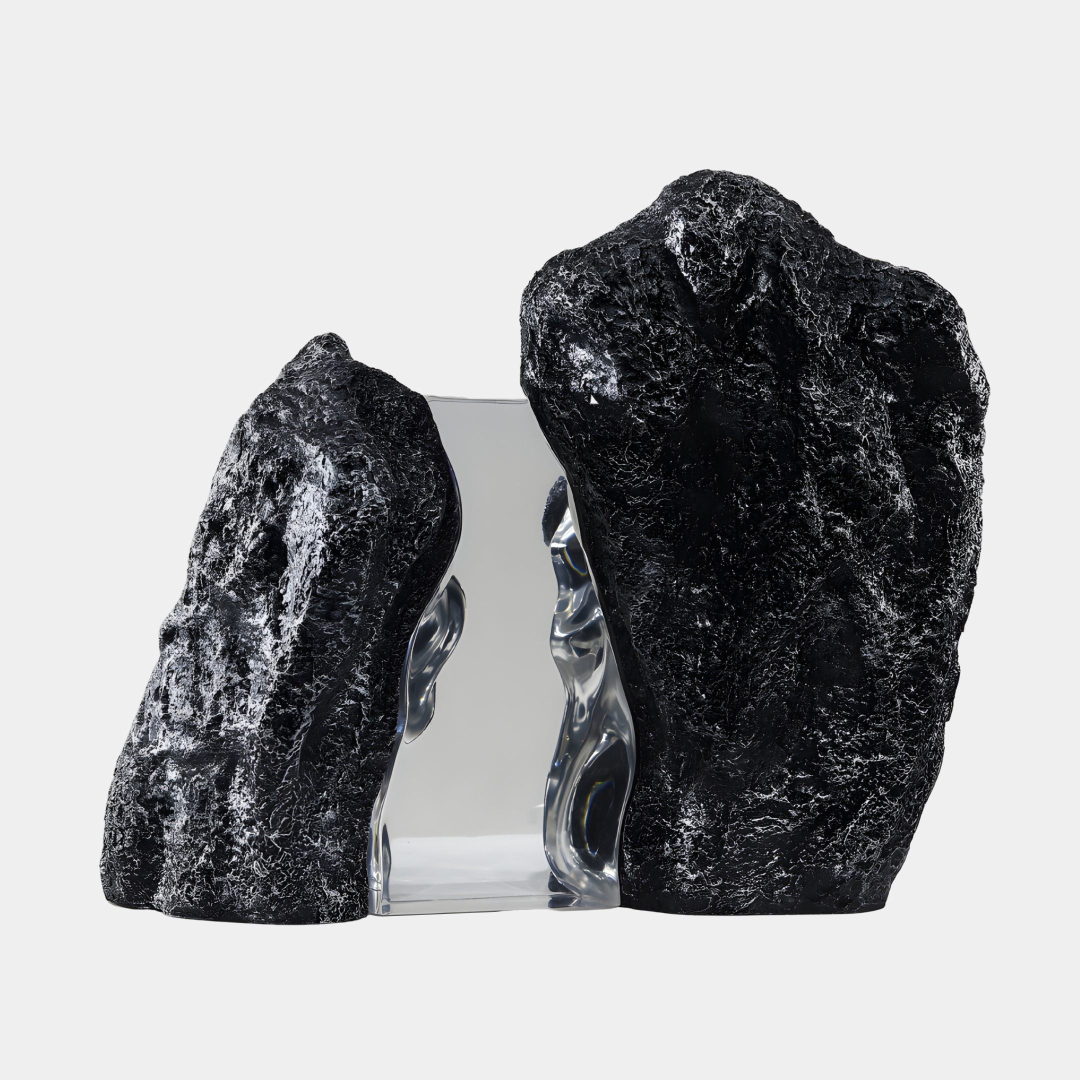 Clear Split Crystal & Dual Rock Peak Resin Sculpture by Giant Sculptures, with a transparent crystal block between two textured black rock peaks on a plain background.