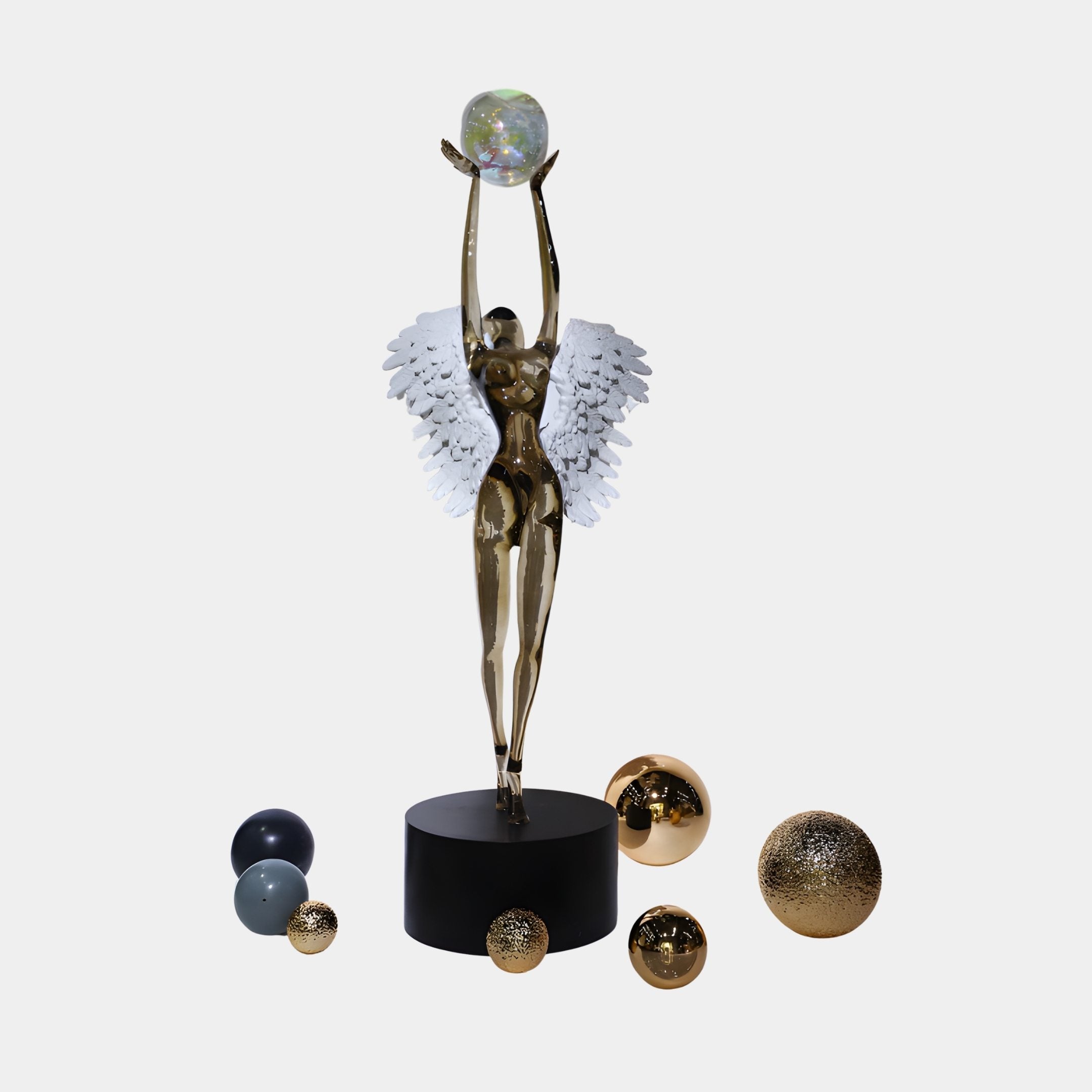 Gold Angel Figurine with Celestial Spheres Resin Sculpture by Giant Sculptures, reaching upward with white wings to hold an iridescent orb on a black base.