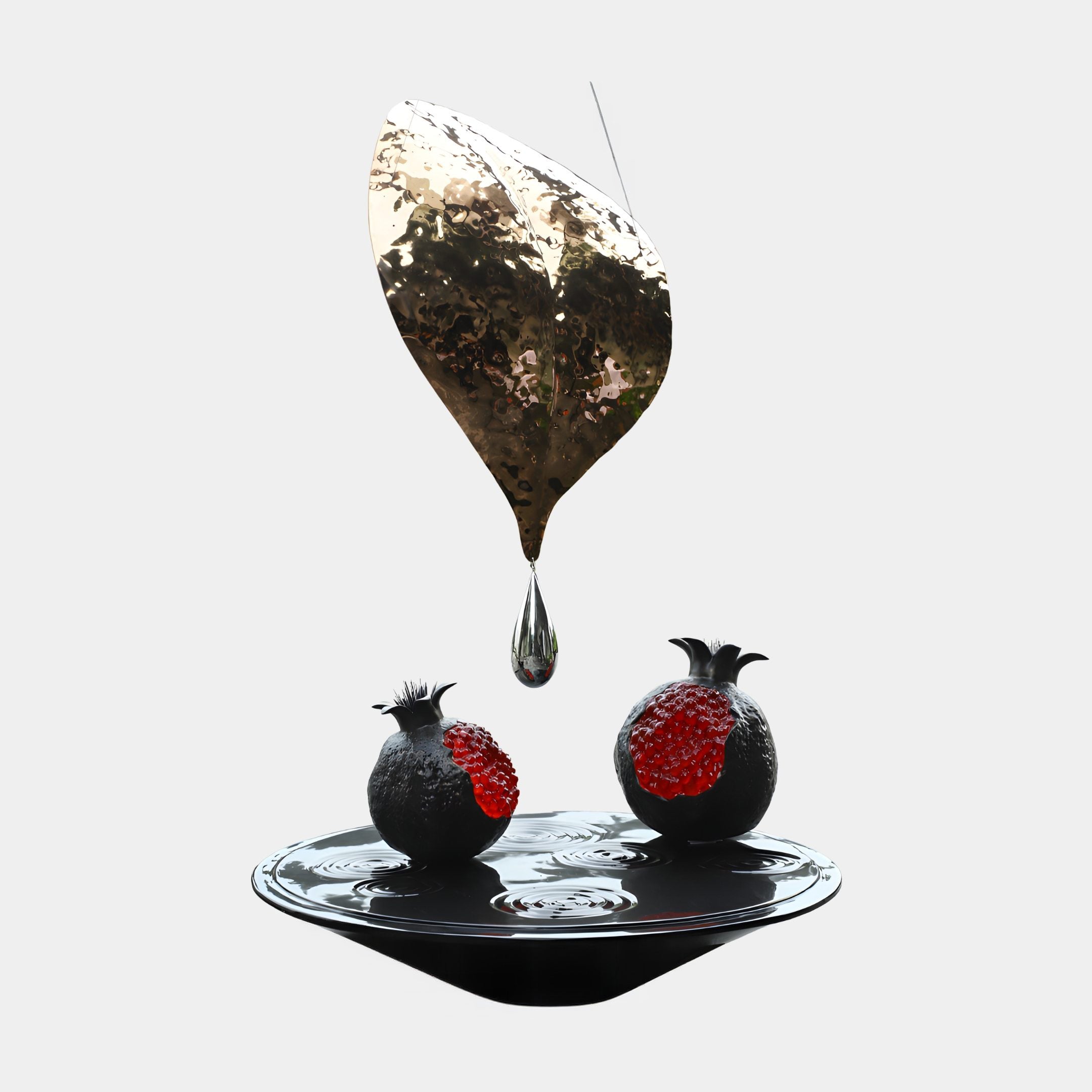 Gold Leaf & Dual Seeded Pomegranate Resin Sculpture by Giant Sculptures, with a hammered gold leaf, suspended droplet and two red-seeded pomegranates on a black disc.