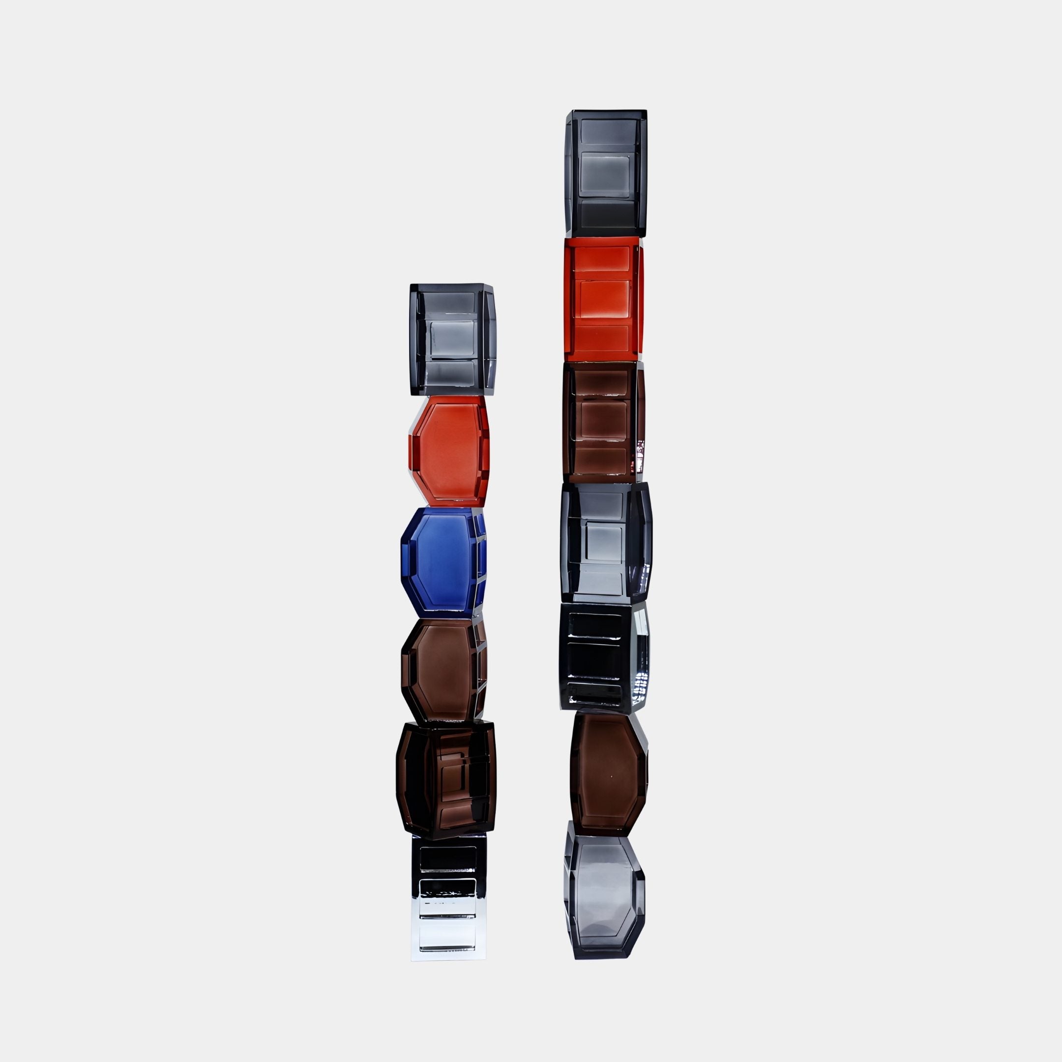 Two Multi-Colour Stacked Glass Block Column Sculptures by Giant Sculptures in red, blue, amber and smoky tones, displayed against a plain white background.