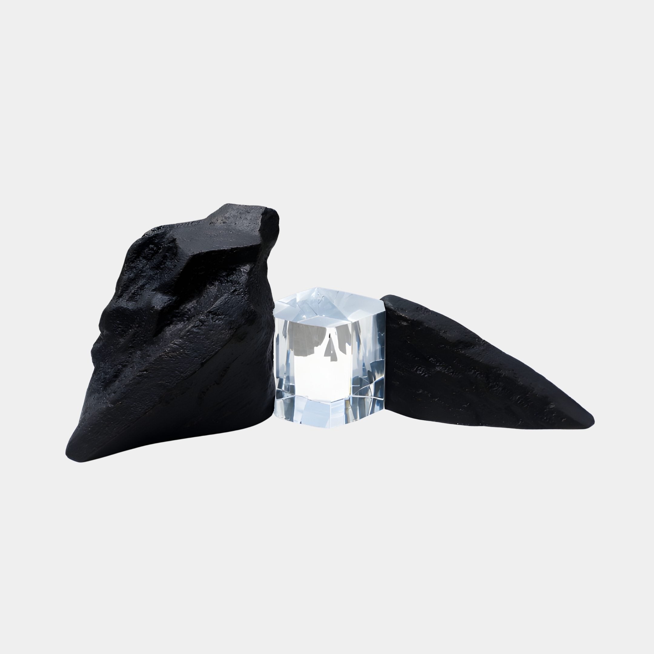 Clear Resin Cube & Dual Black Rock Sculpture by Giant Sculptures, featuring a faceted transparent block flanked by two tapered matte black rock forms on a white background.