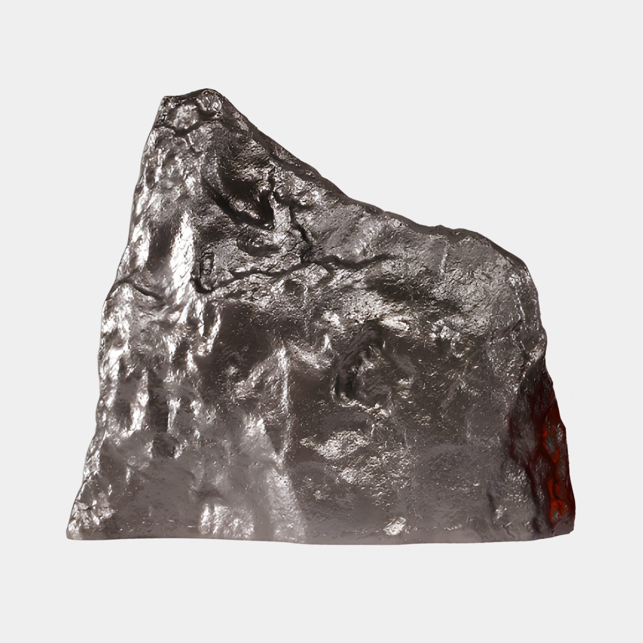 Giant Sculptures Pewter Silver Jagged Rock Fiberglass Sculpture, 72cm, with textured metallic surface and a warm red glow at one edge, on a plain background.