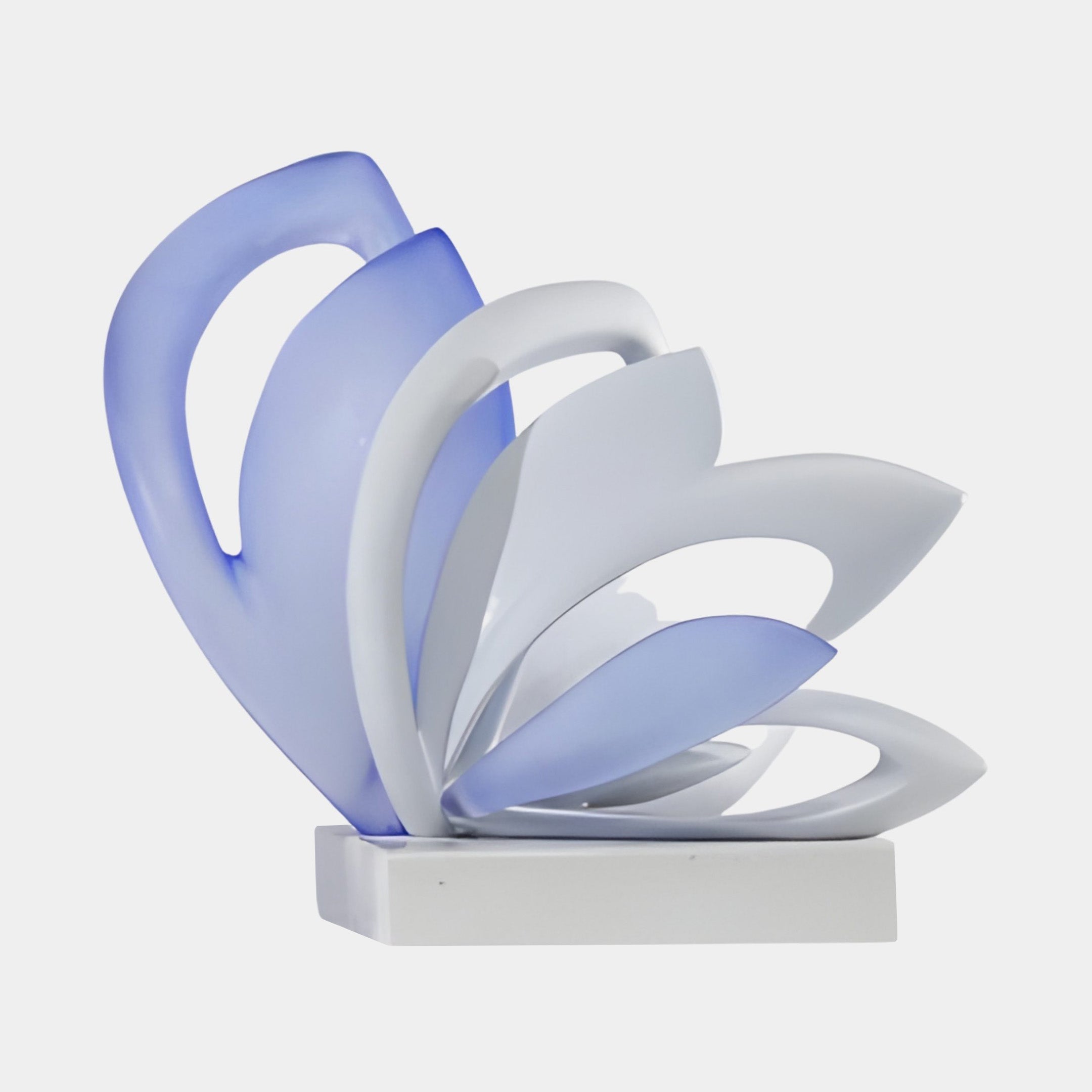 Frosted Violet & White Abstract Petal Bloom Sculpture by Giant Sculptures, layered violet-blue and white petals fanning outward on a white base, plain background.