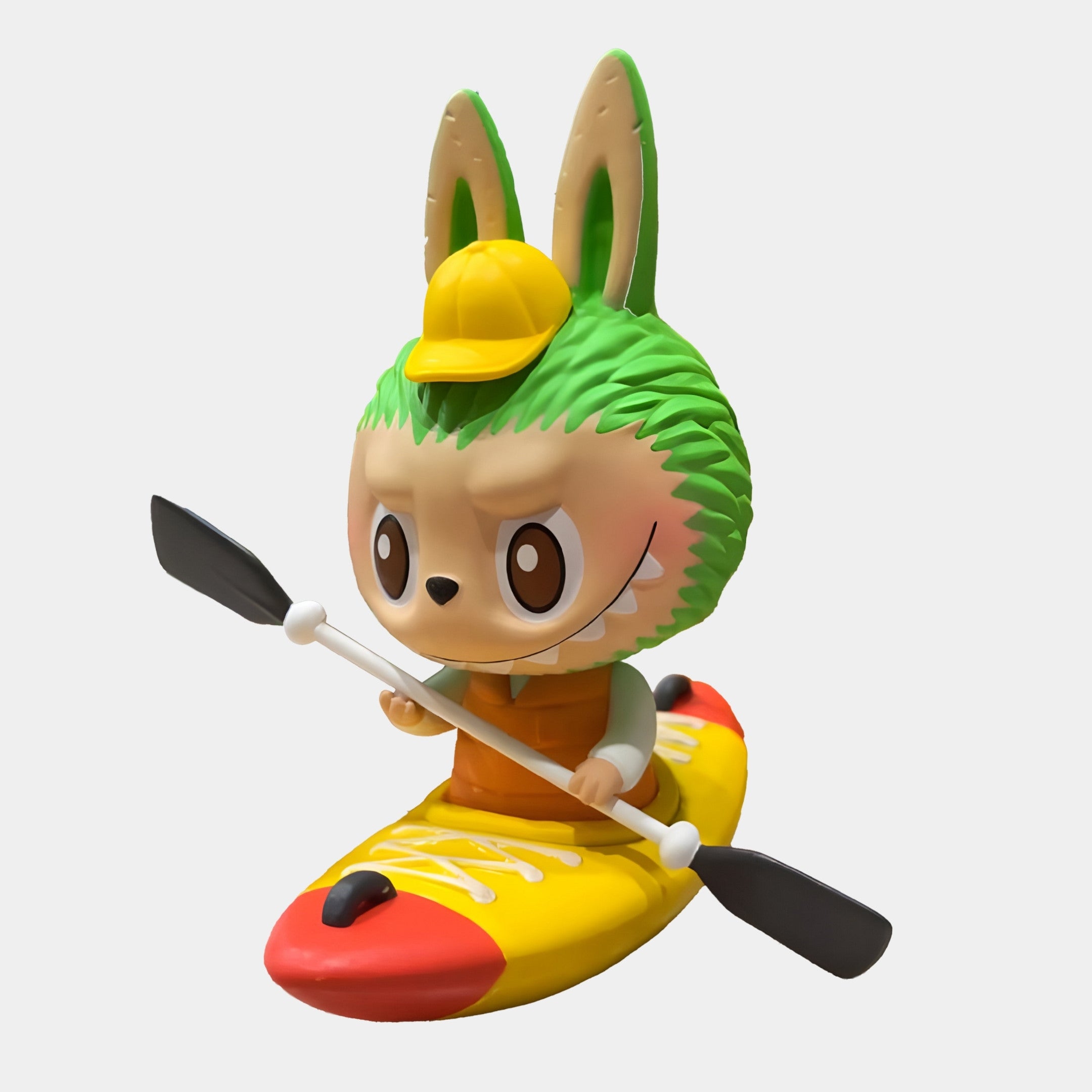 The Giant Sculptures Camp Life Kayaker Labubu Sculpture - 160cm features Labubu with rabbit ears, green hair, a yellow cap, orange vest, and wide eyes in a yellow-red kayak holding a black paddle—perfect as an indoor display.