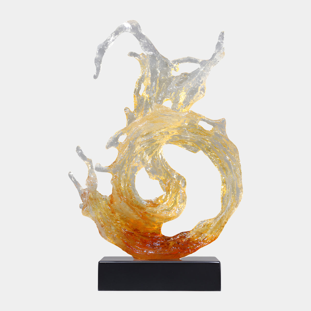 Amber Crystalline Wave Curl Resin Sculpture (66cm) by Giant Sculptures, a swirling wave form curling into a ring with flame-like crests, clear to amber tones, on a black rectangular base against a plain white background.