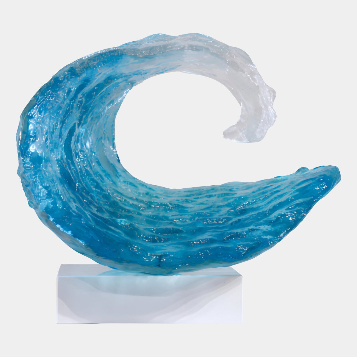 Turquoise Granular Wave Curl Resin Sculpture, 60cm, curling from deep blue to clear white at the tip, on a white block base against a plain background.