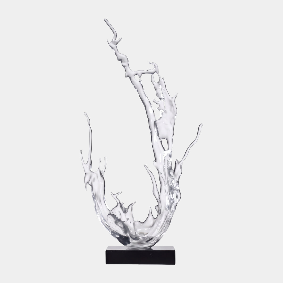 Clear Leaning Splash Spire cast resin sculpture, 64cm, rising from a curved cup-like base to a slender pierced spire, on a black block, white background.