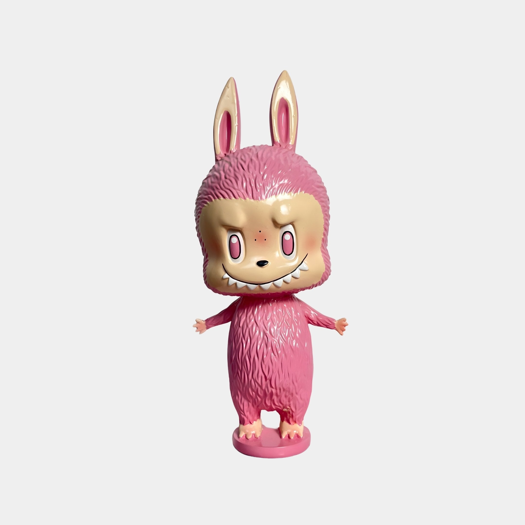 Brighten your space with the 28cm Little Monster Pink Labubu Figure by Giant Sculptures, a charming pink collectible toy featuring an adorable cartoon face.