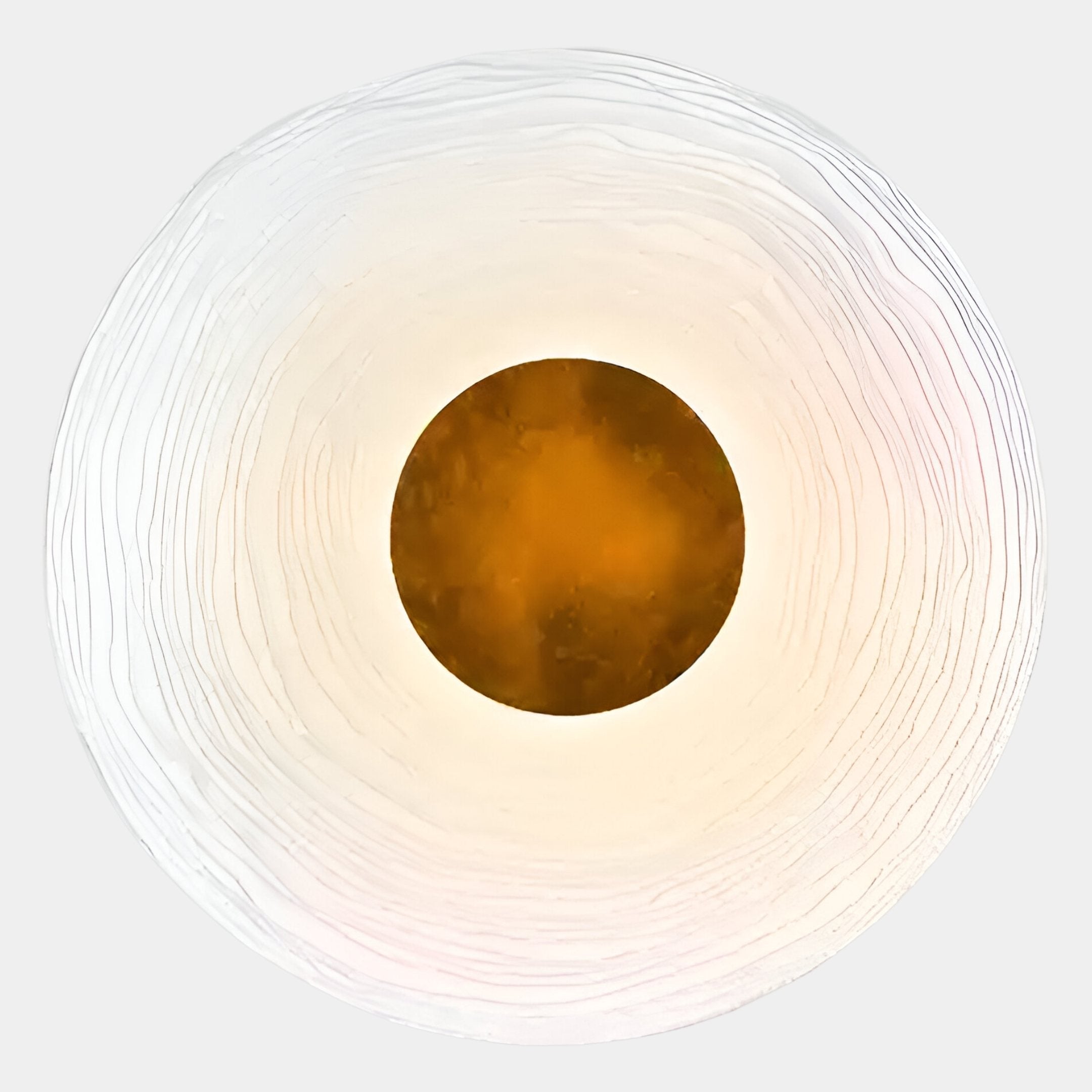 The Ventus Amber Glow Wood Carving 3D LED Wall Art from Giant Sculptures features a textured white ring and smooth amber center, casting a subtle amber glow against a light gray background.