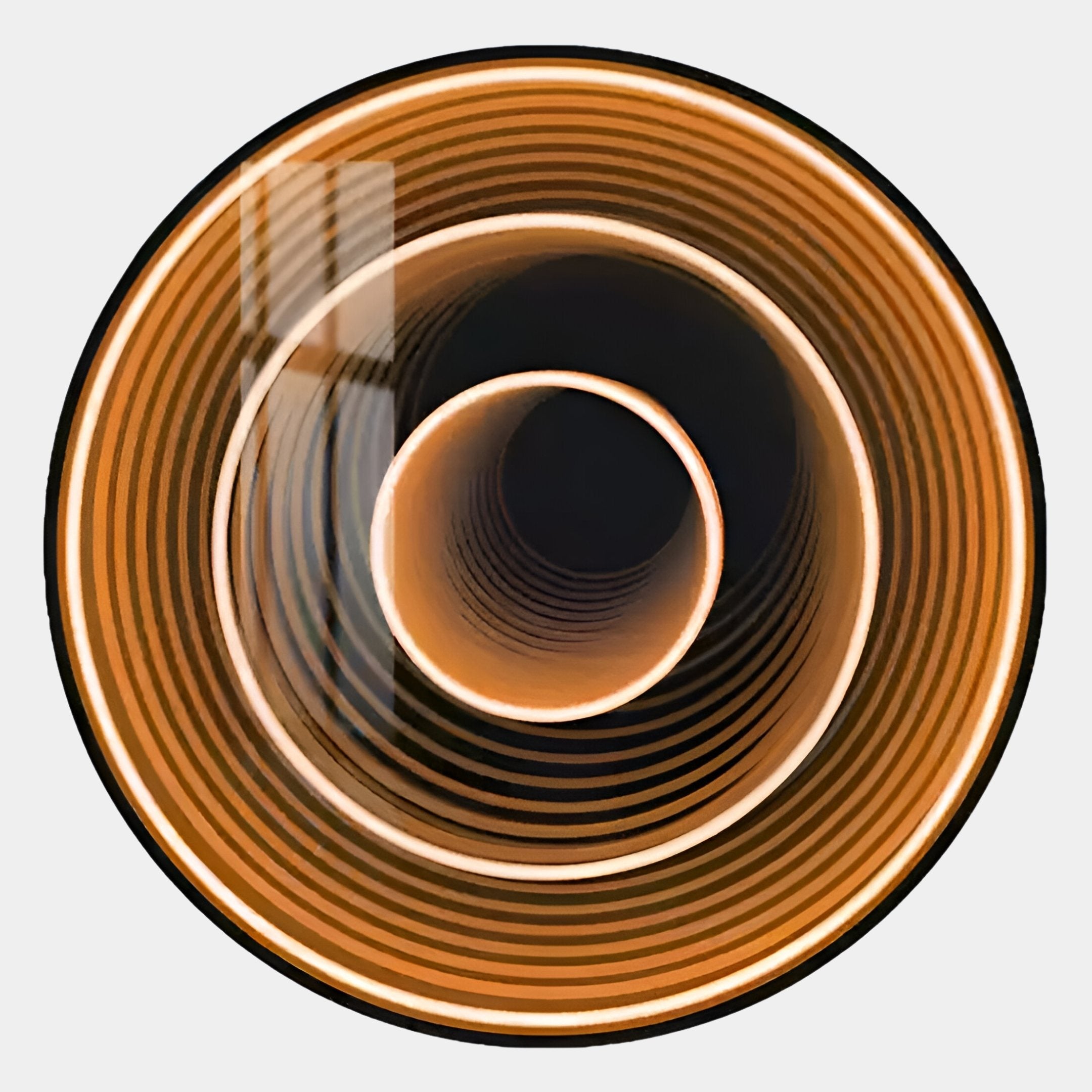 A top-down view of concentric orange and brown rings with a reflective light streak, this abstract image captures the hypnotic allure of the Reflex Gold Mirror 3D LED Wall Art by Giant Sculptures.