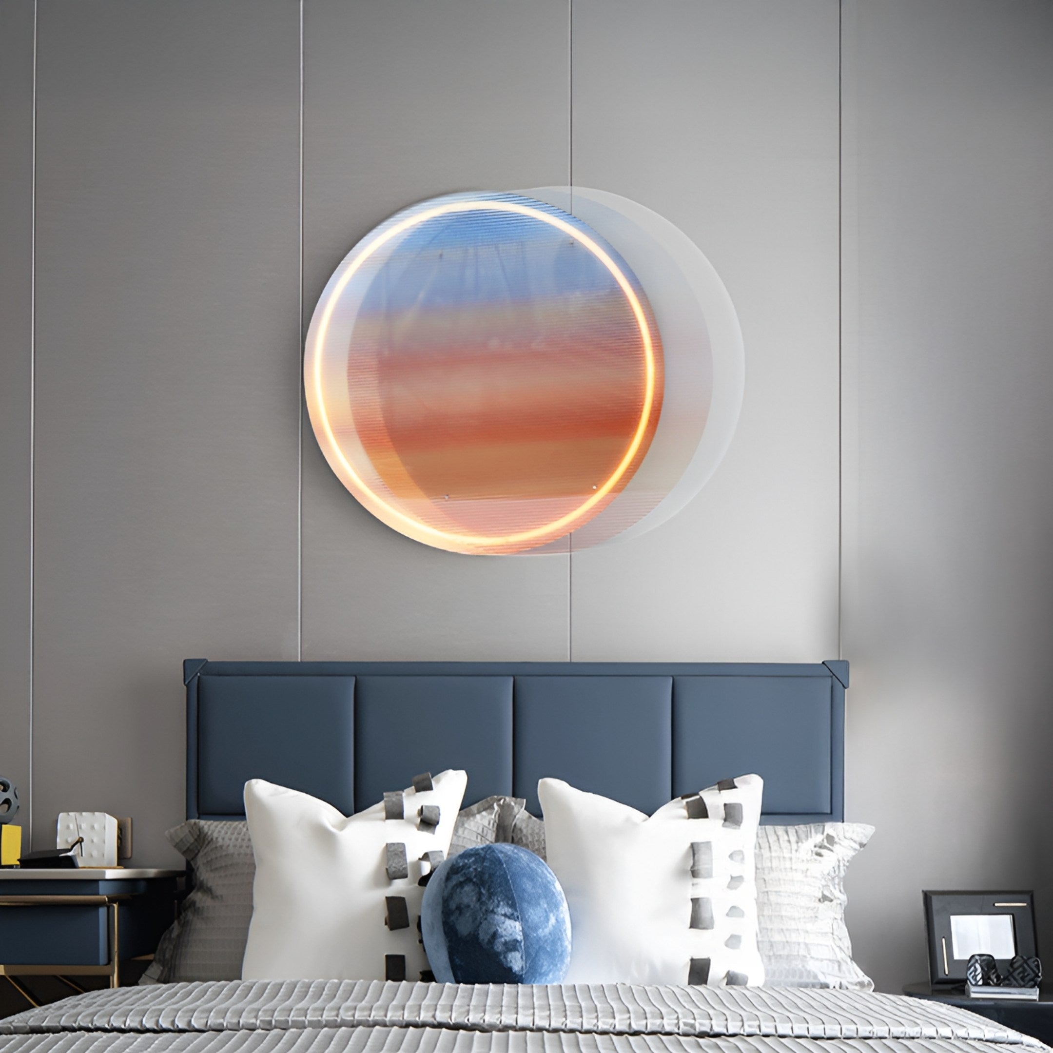 A modern bedroom with a blue upholstered headboard, white pillows with black accents, and the Chromia Sunrise Glow Acrylic 3D LED Wall Art by Giant Sculptures—featuring soft dimmable LED light—mounted above the bed on a gray paneled wall.