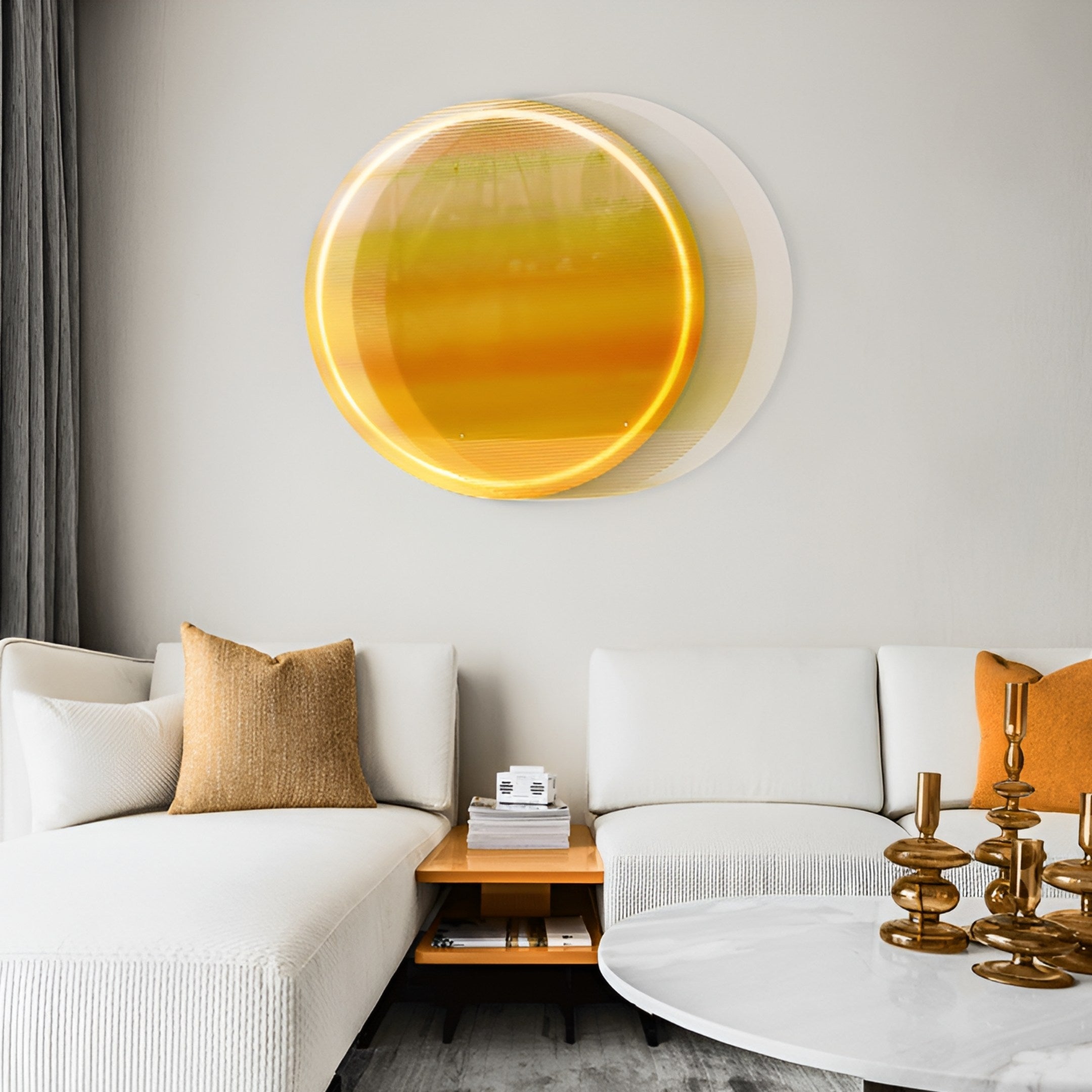 A modern living room with a white sectional sofa, gold and orange pillows, a round white coffee table with gold candleholders, and the striking Giant Sculptures Chromia Golden Horizon Acrylic 3DLED Wall Art above the couch.