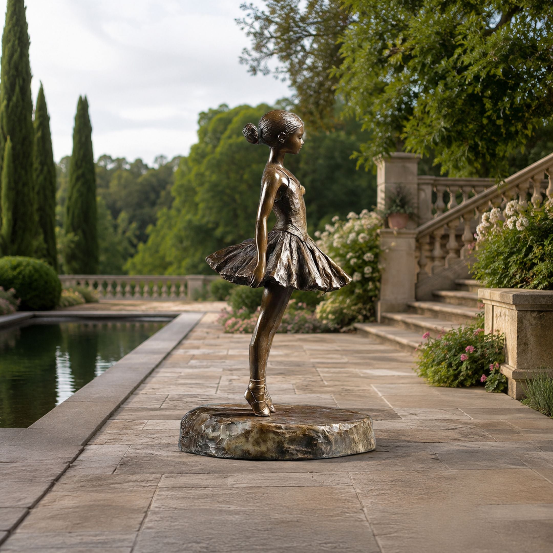 Life-Size Contemporary Ballerina Bronze Sculpture, 190cm, on a stone base beside a garden pool with balustrade stairs and greenery.