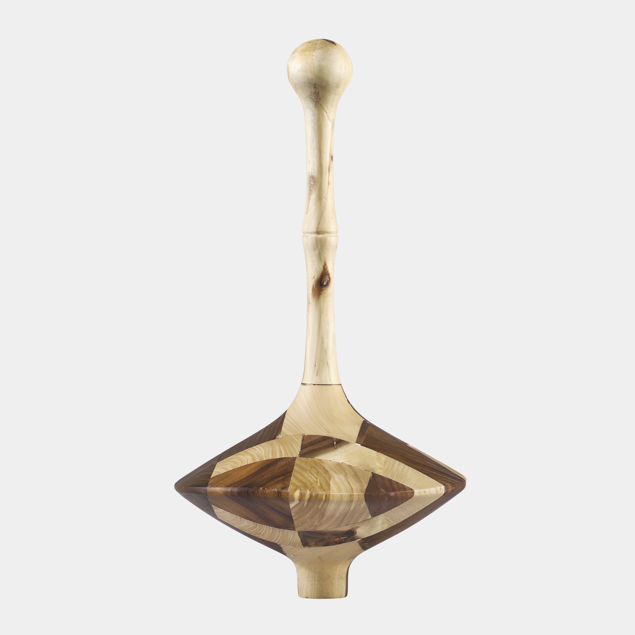 Giant Sculptures Two-Tone Wood Spinning Top Sculpture 45cm with a cream stem, round handle ball, and faceted cream and walnut diamond body on grey.