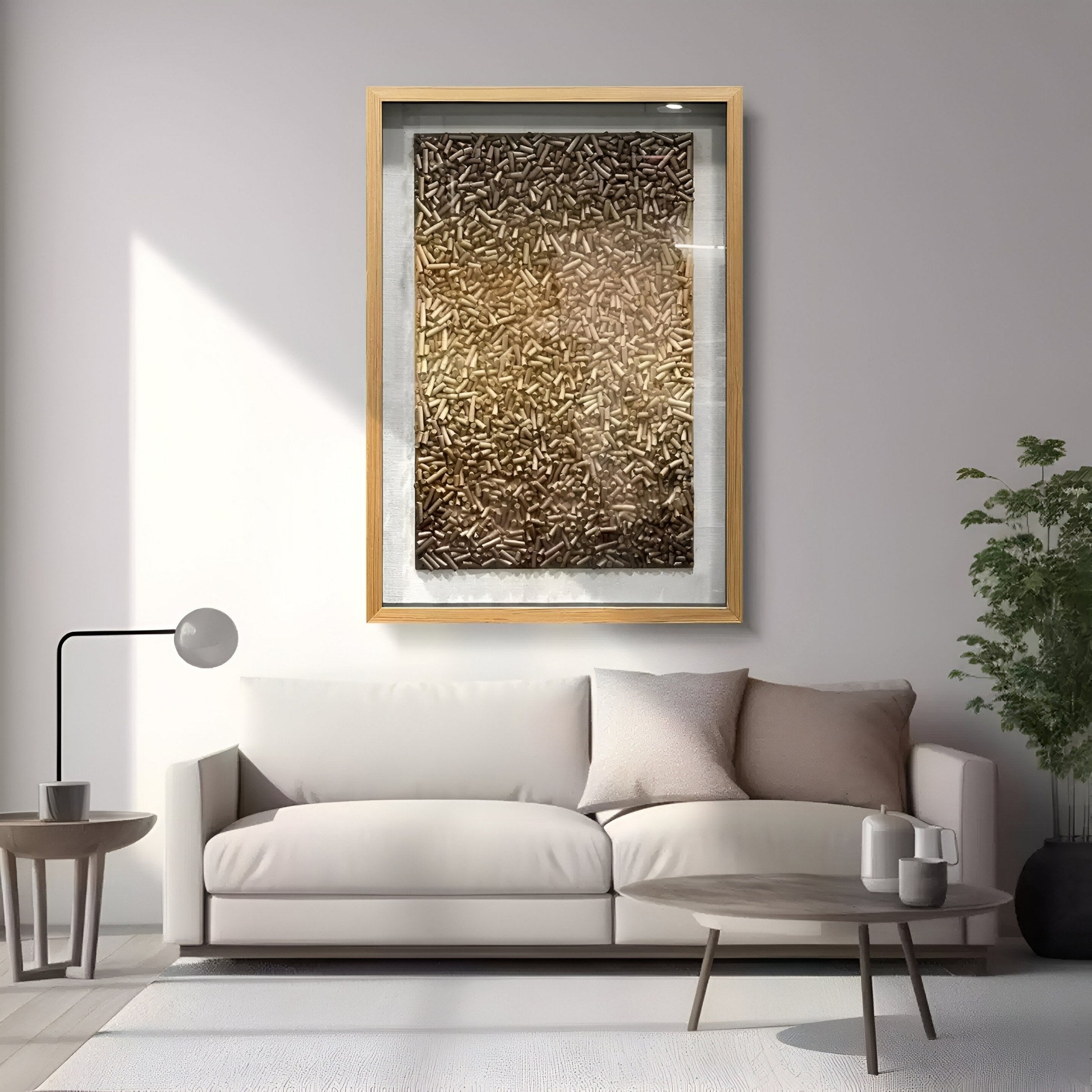 A modern living room featuring a white sofa, round wooden coffee table, potted plant, floor lamp, and the Brivora Golden Bronze Gradient Textured 3D Wall Art by Giant Sculptures above the couch.