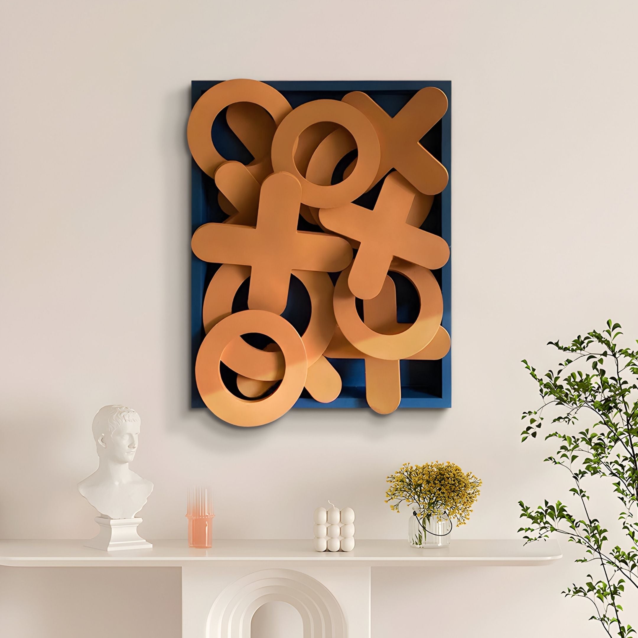 A modern living room with a white mantelpiece, decorative objects, a vase of yellow flowers, and a vibrant green plant showcases the Typova Burnt Orange X&O Wood Carving 3D Wall Art by Giant Sculptures for bold Nordic-inspired decor.
