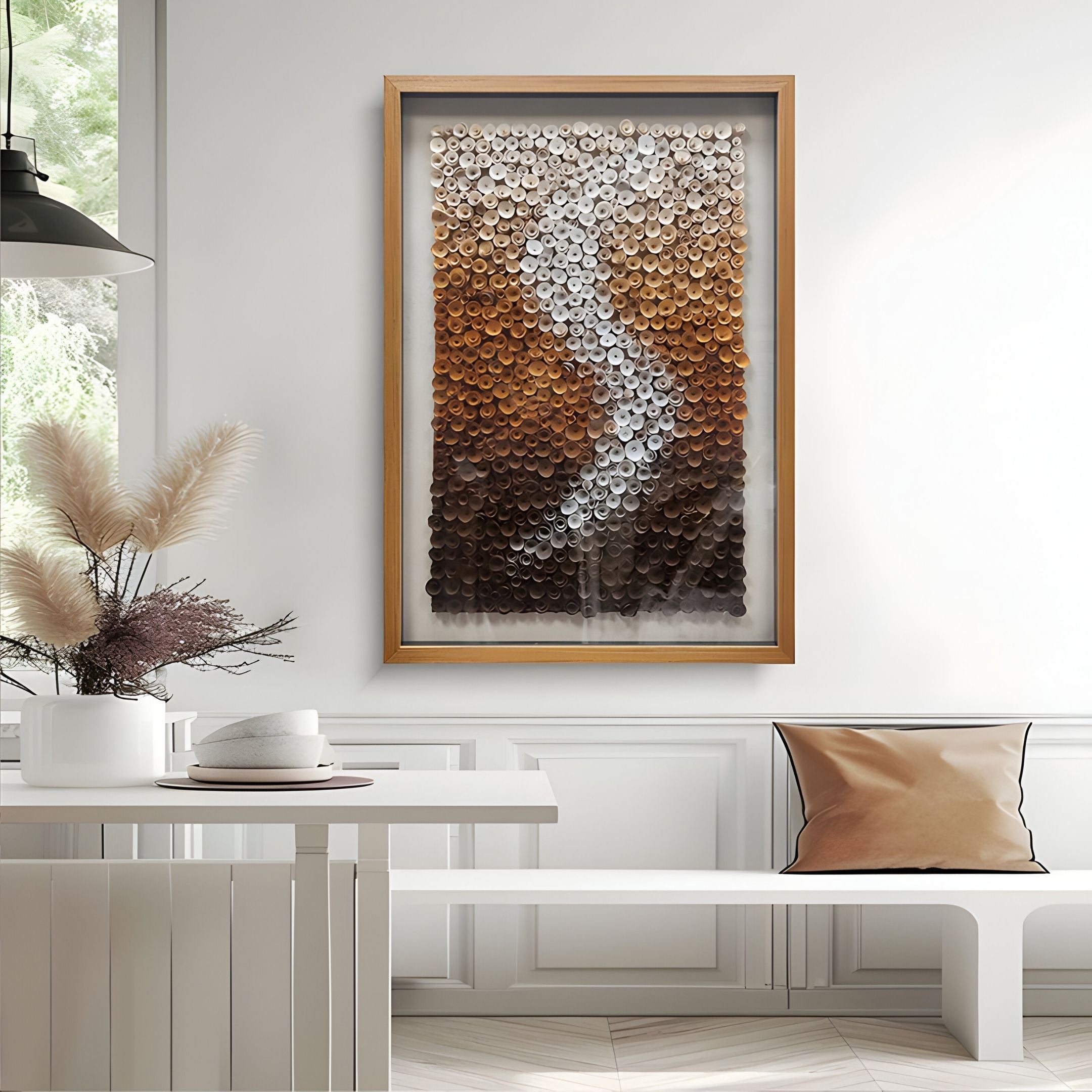 A modern, minimalist room features a white table, neutral pillow, pampas grass vase, and above the bench hangs the Spiravale Amber Gradient Floral Curl 3D Wall Art by Giant Sculptures, adding depth with its brown and white textured design.