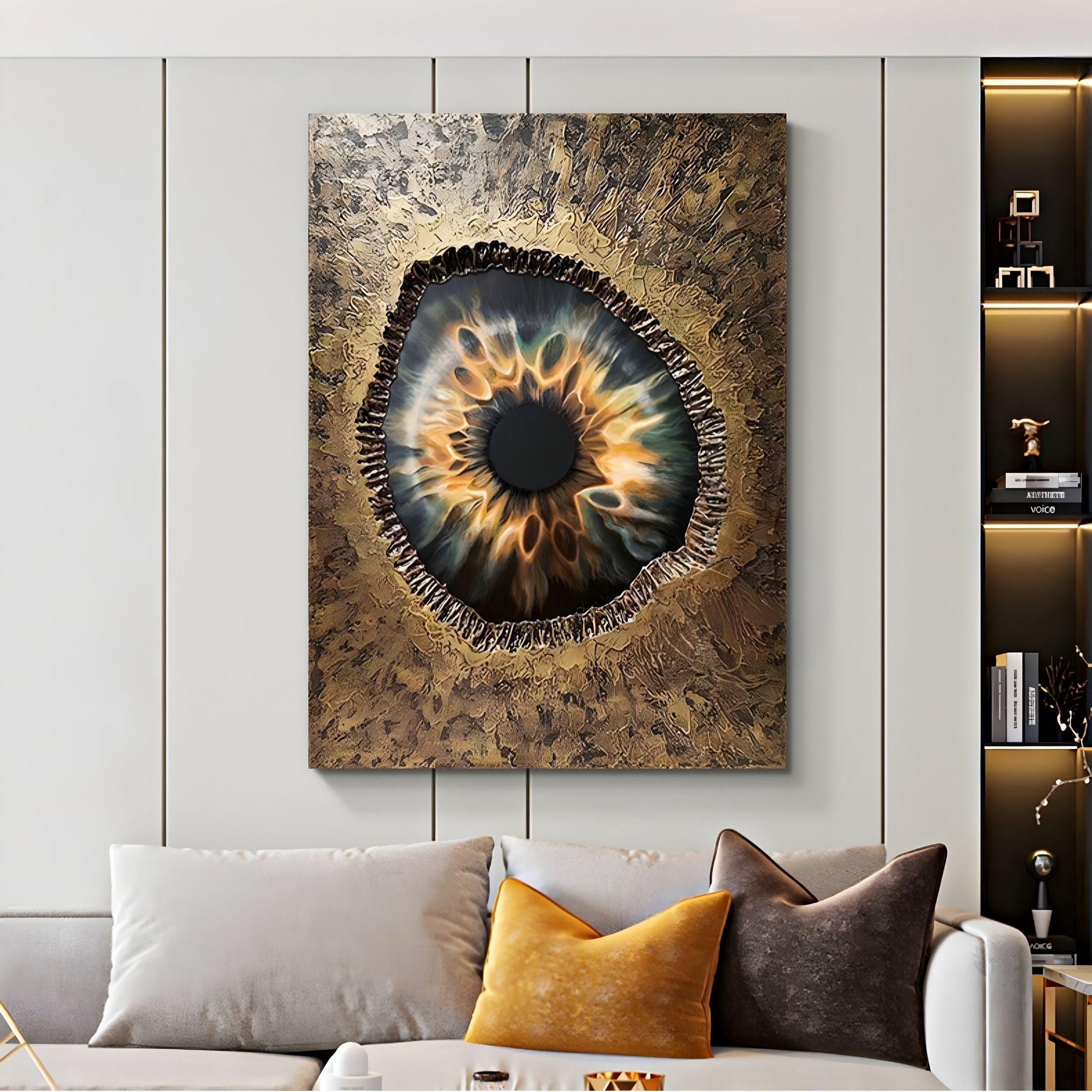 A modern living room displays the Vorthera Amber Flame Textured Gold 3D Wall Art by Giant Sculptures above a light gray sofa with beige, gray, and gold pillows. Shelves with decor are visible on the right.