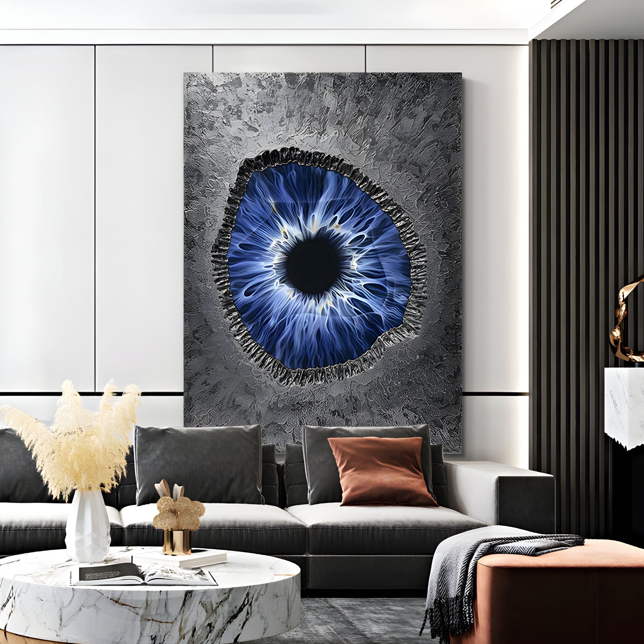 A modern living room showcases the Vorthera Midnight Iris Textured Silver 3D Wall Art by Giant Sculptures above a gray sofa, complemented by a marble coffee table and brown, gray, and white accents for a stylish, contemporary look.