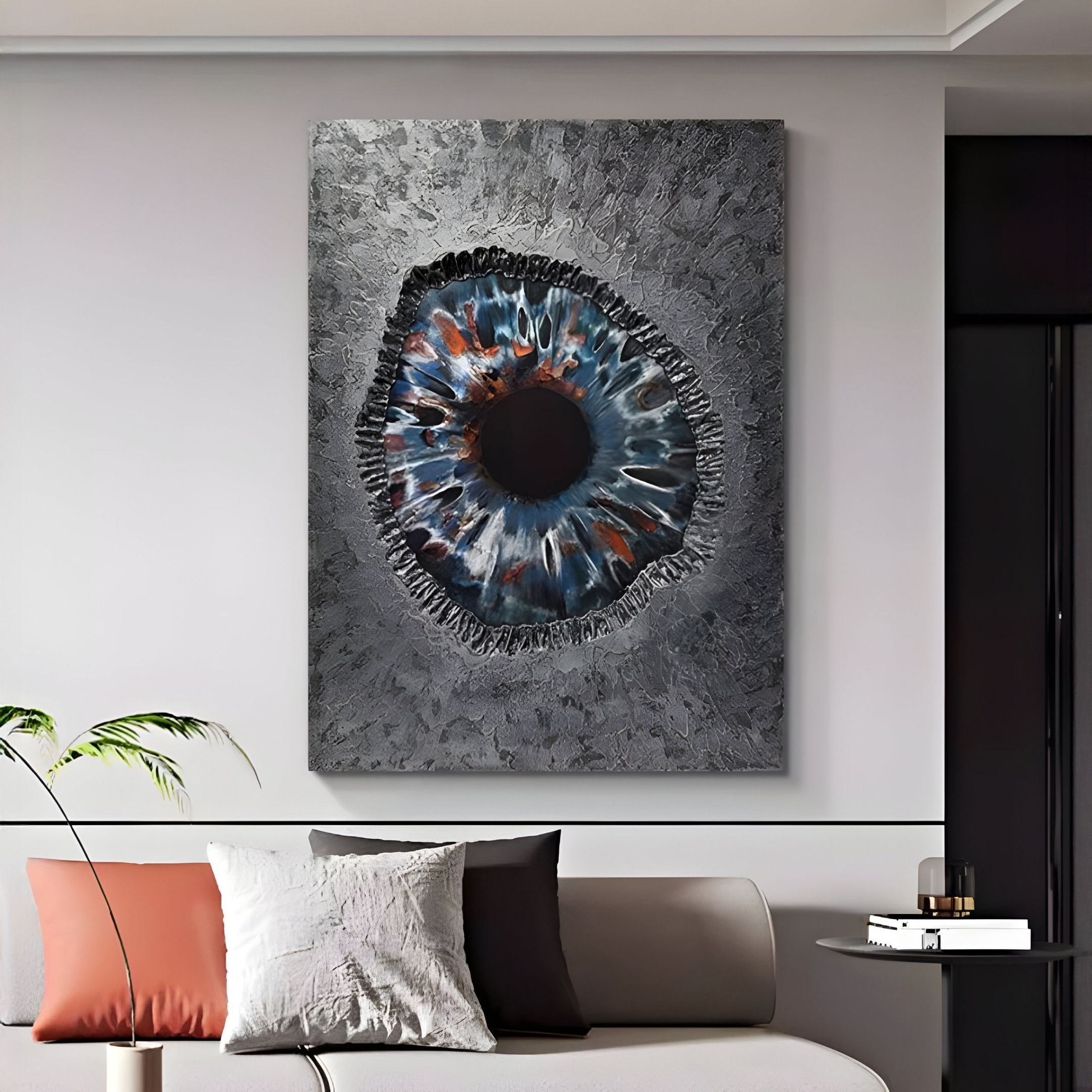 A modern living room showcases the Vorthera Steel Rift Textured Silver 3D Wall Art by Giant Sculptures on a gray wall above a sofa with white, gray, and brown cushions—perfect for stylish contemporary interiors.