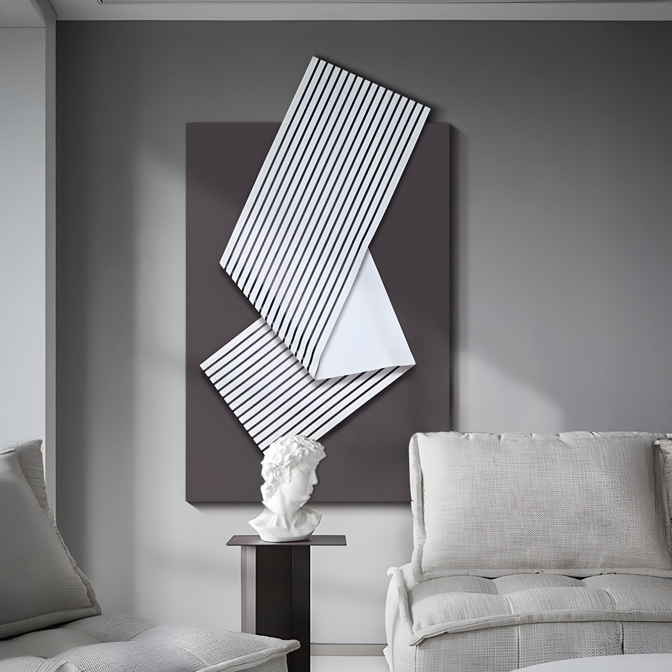 A modern living room featuring light gray armchairs, a classic white bust, and the Arcluma Charcoal Stripe Fold Leather 3D Wall Art by Giant Sculptures—geometric and abstract, ideal for modern minimalist decor lovers.