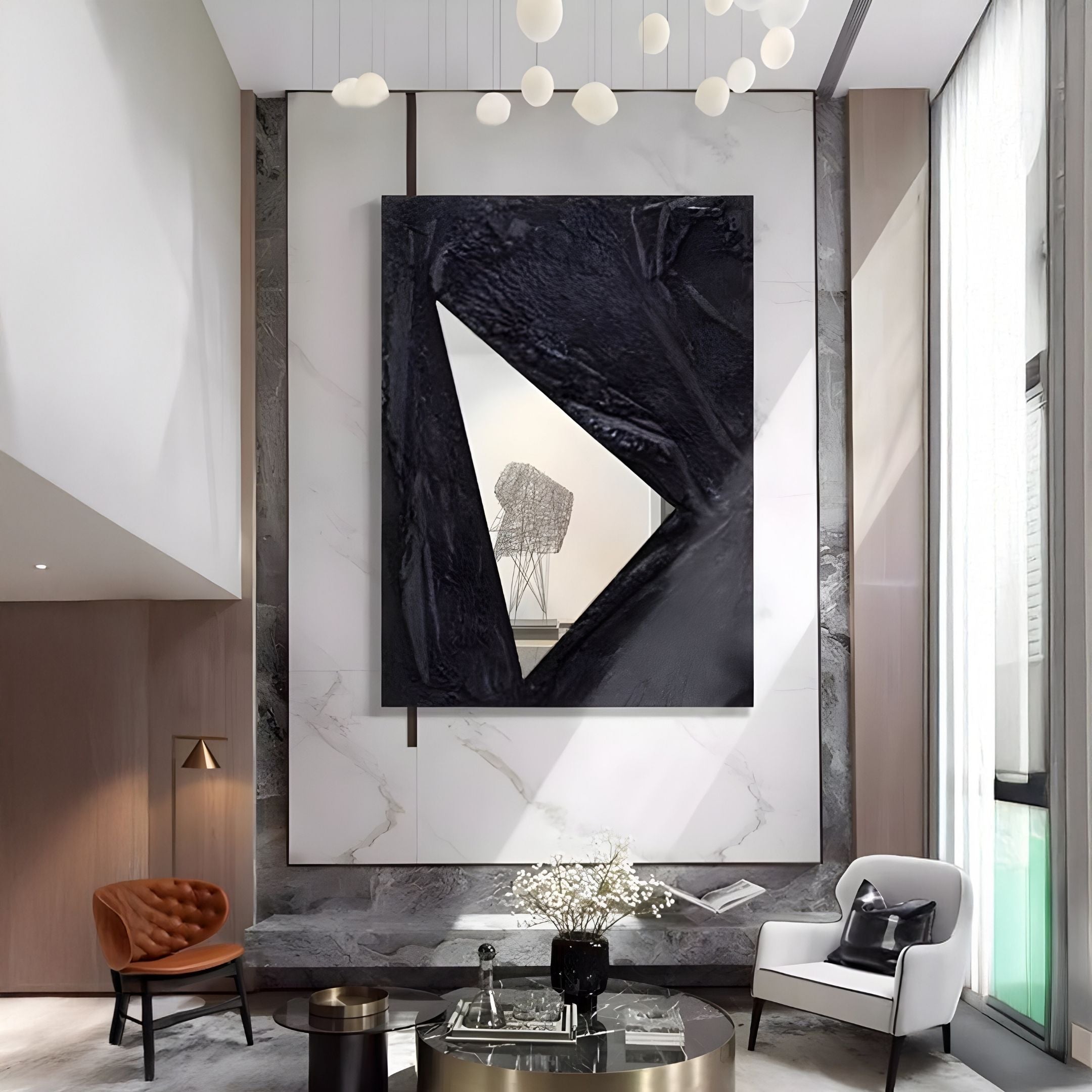 A modern living room with high ceilings features the Giant Sculptures Arclunor Black Triangle Relief Mirror 3D Wall Art, marble walls, contemporary white and brown chairs, a round glass coffee table, and dramatic black-framed abstract accents.