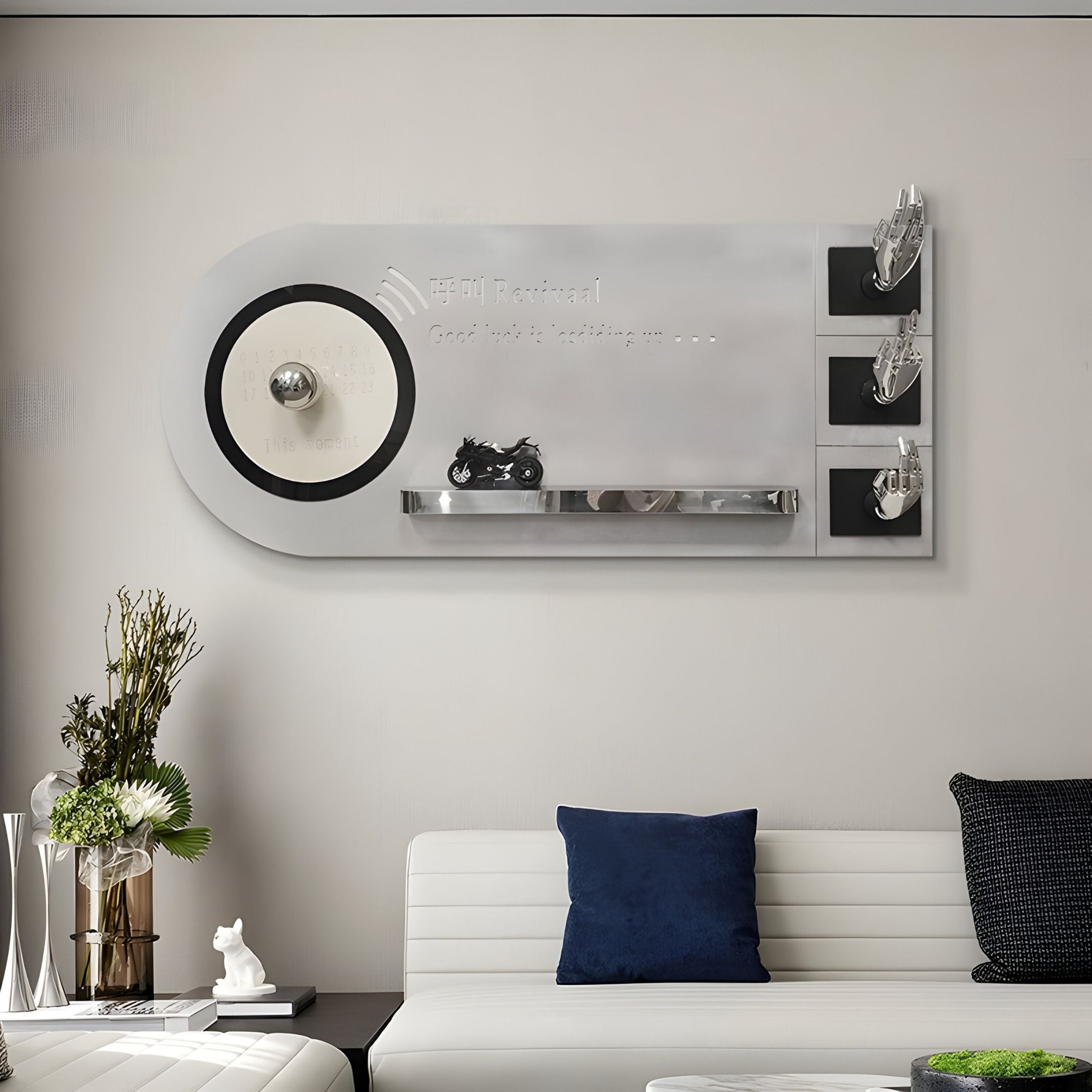 A modern living room features a white sofa, blue cushion, and the Nexivra Silver Techscape Interactive 3D Wall Art by Giant Sculptures, with motorcycle motifs and metallic hooks. Small motorcycle models and a flower arrangement complete the scene.