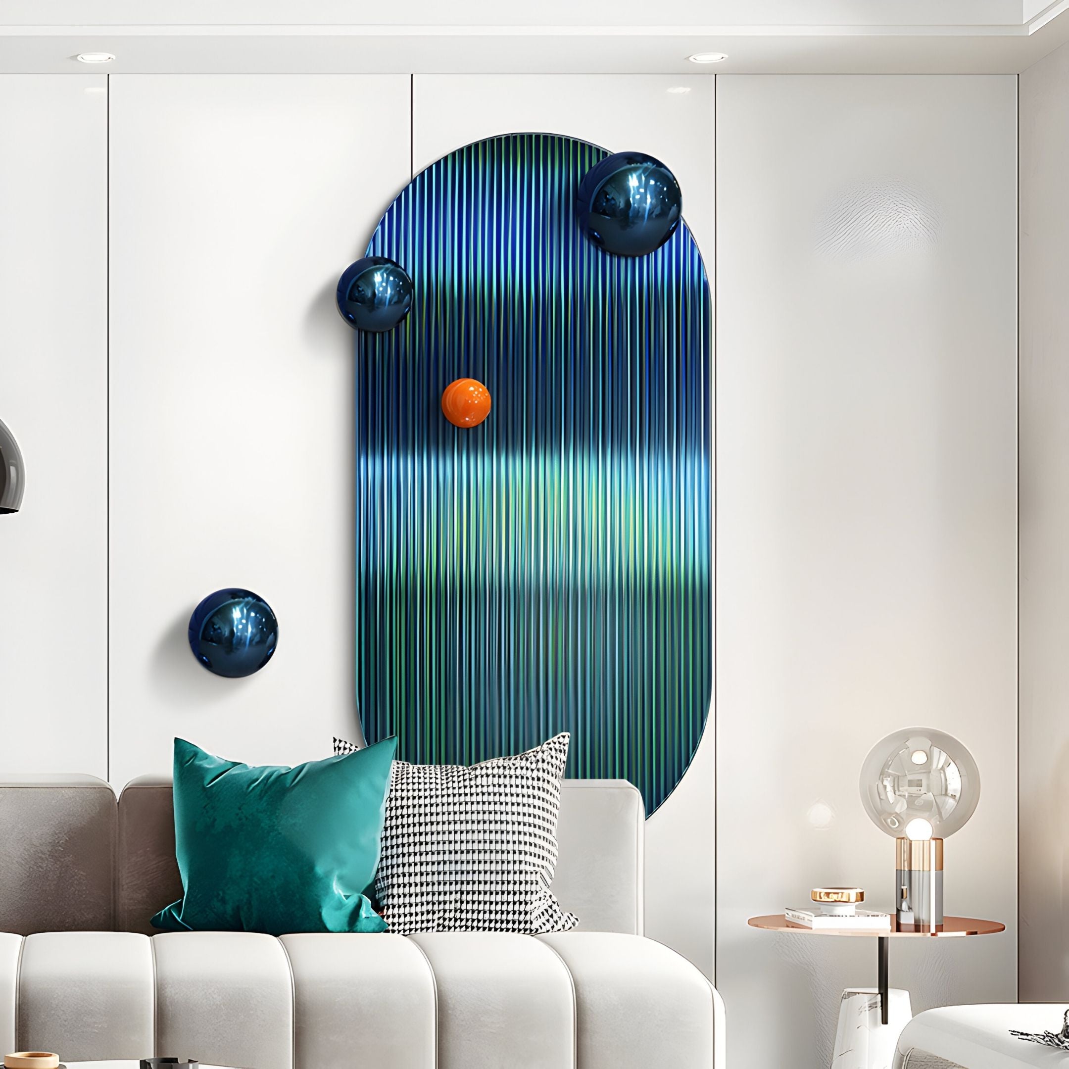A modern living room showcases the Virellon Blue Gradient 3D Wall Art With Orange Metal Balls by Giant Sculptures—a striking oval piece with blue and green tones, shiny blue spheres, and a smaller orange sphere above a gray sofa with teal pillows.