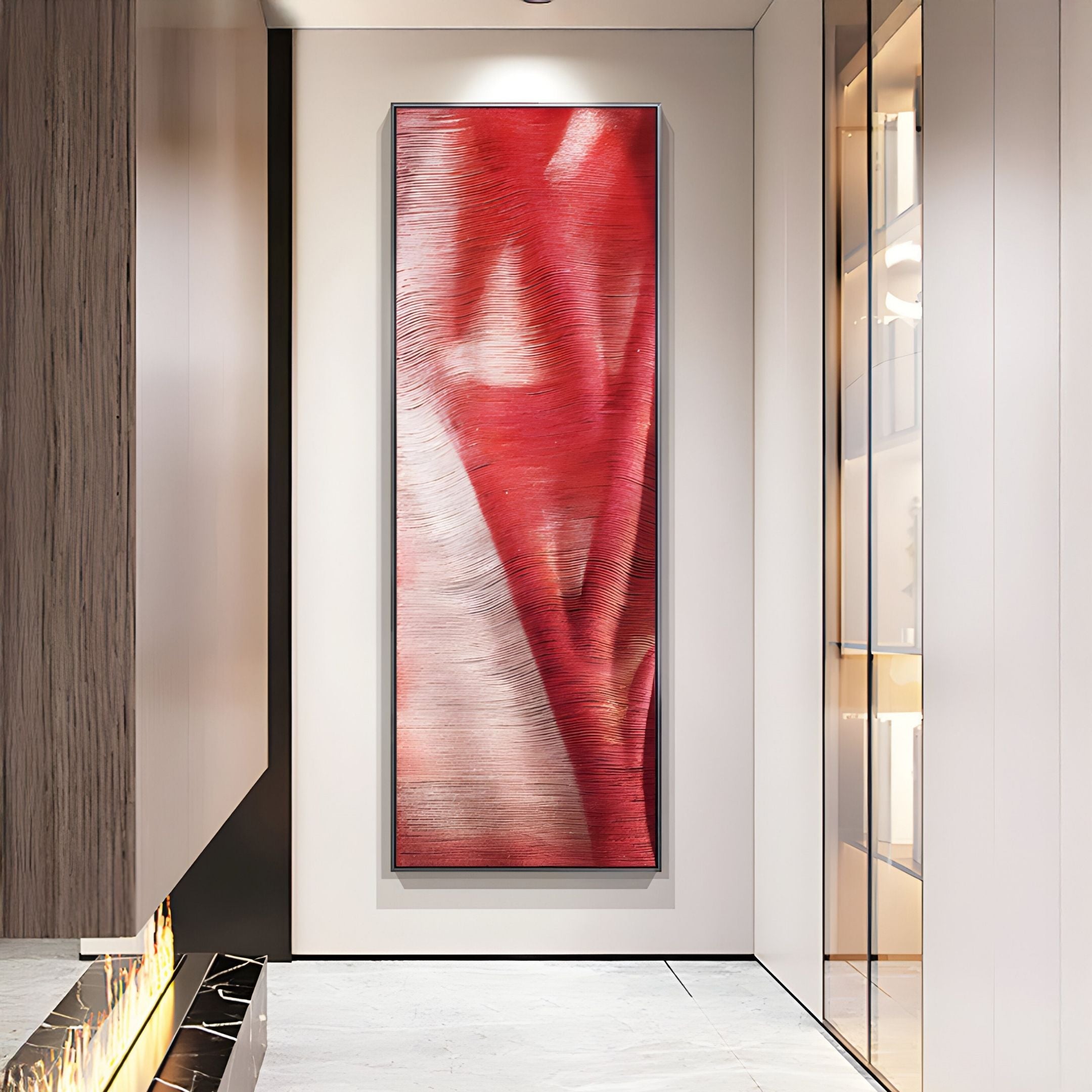 A modern hallway showcases Giant Sculptures' Rivara Crimson Wave Vertical Hand-Painted Rope 3D Wall Art in red and white, the statement piece against sleek neutral walls and marble flooring.