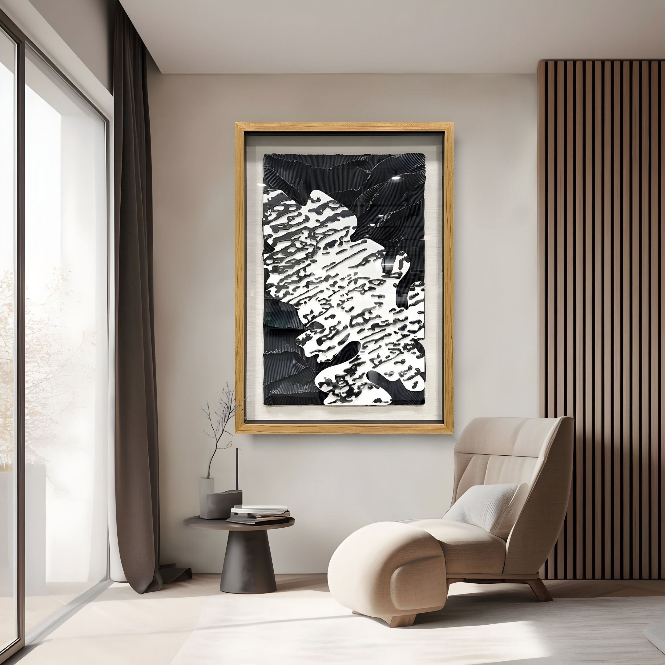 A modern living room showcases Giant Sculptures’ Vanterra I Black & White Flow Framed 3D Wall Art, a beige lounge chair with ottoman, a small round black table, and floor-to-ceiling windows with sheer curtains.