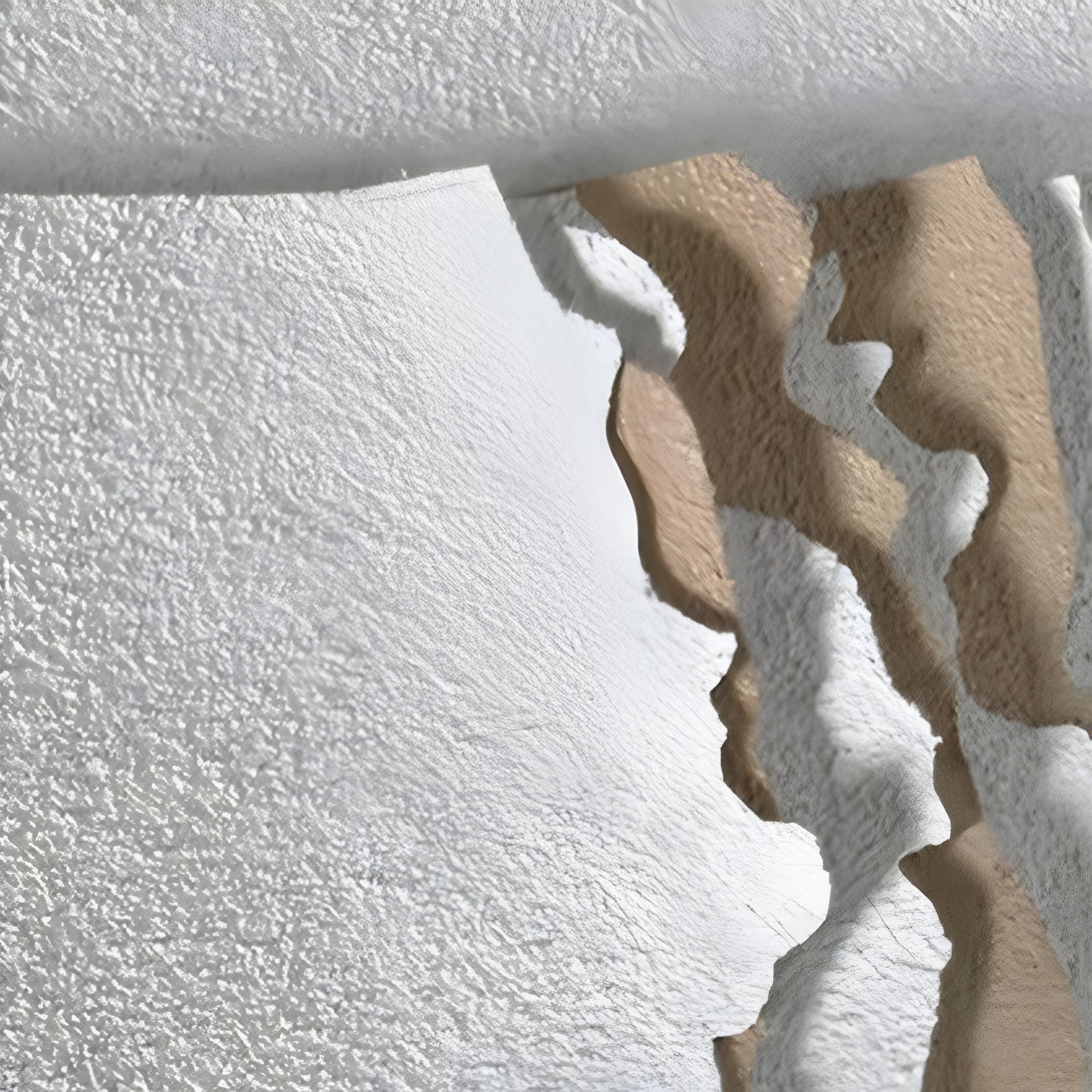 Aerial view of a polar landscape with snowy white and brown textures, echoing the curving edges and patterns of Giant Sculptures' Rivura White Layered Sandstone Texture 3D Wall Art.