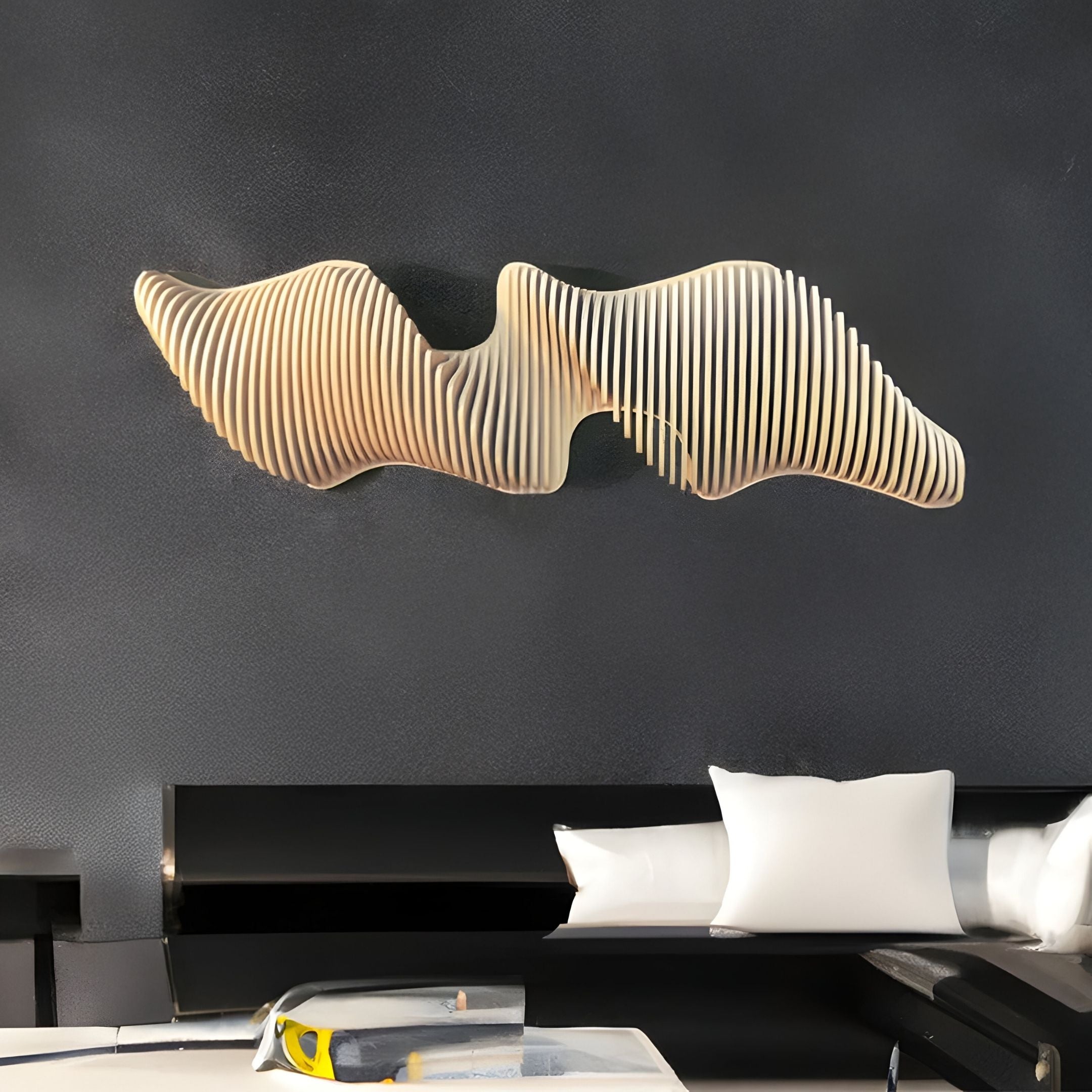 The Aeravox Cream Waveform Sculptural 3D Wall Art by Giant Sculptures, featuring wavy, ribbed wooden slats, is displayed on a dark wall above a white couch with cushions in a contemporary living room.