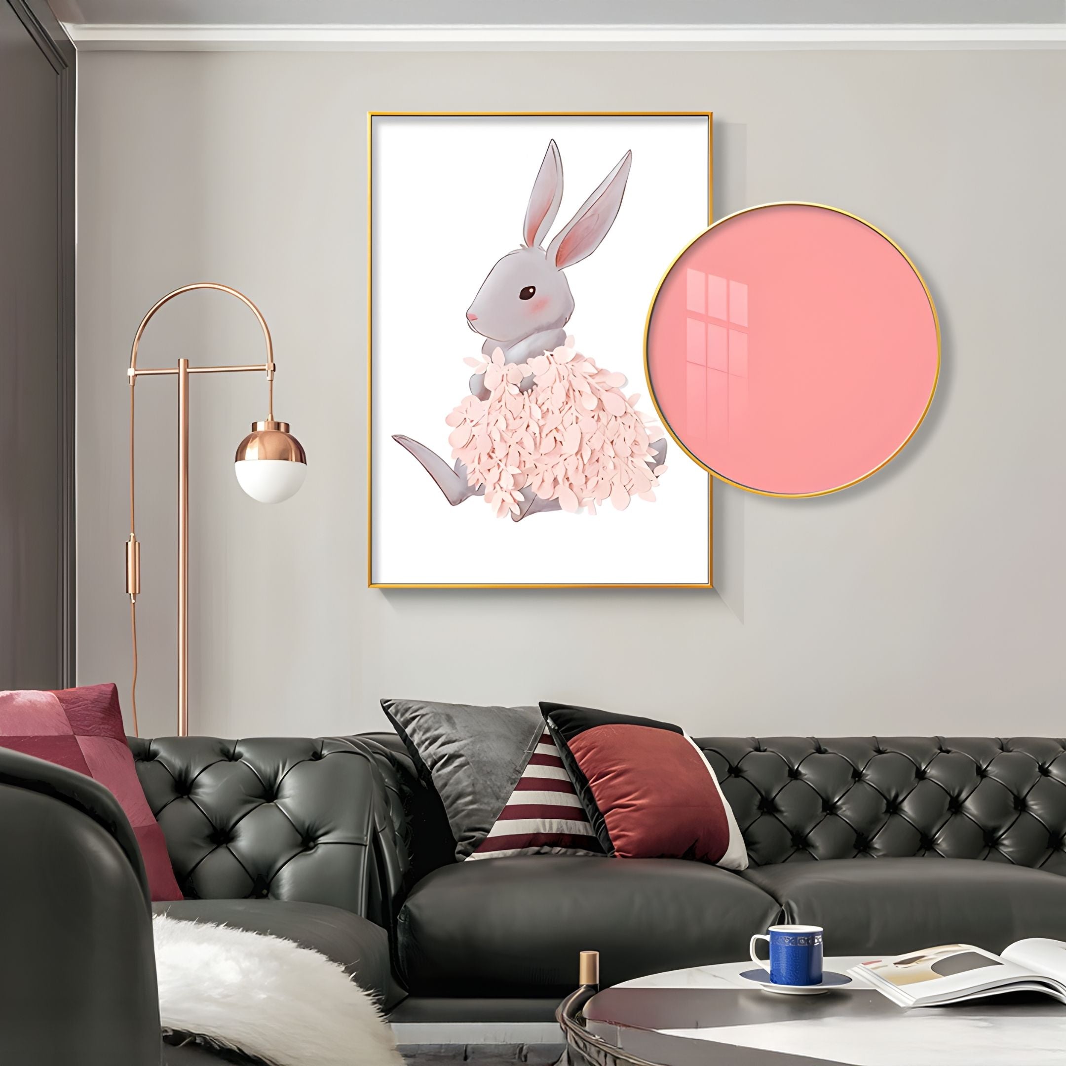A modern living room with a tufted dark sofa, assorted pillows, a round coffee table, and Giant Sculptures' Blossomkin Pink Petal Bunny Kids 3D Wall Art featuring a rabbit with pink flowers. A gold floor lamp stands beside the sofa.