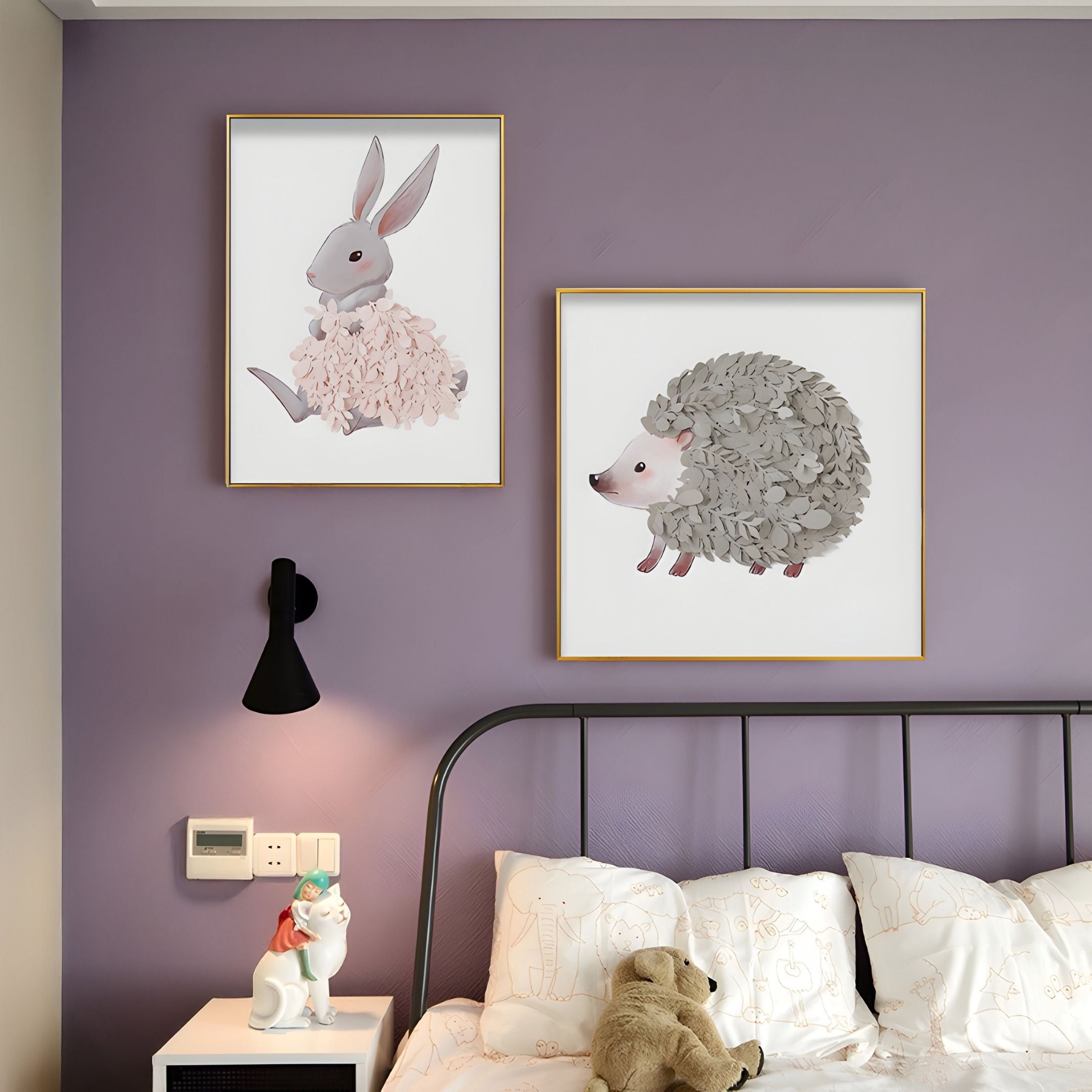 A bedroom with a purple wall features the Blossomkin Bunny 3D Floral Wall Art by Giant Sculptures and a hedgehog print above the bed. A black wall lamp, unicorn figurine, and animal-patterned bedding complete this cozy nursery decor.