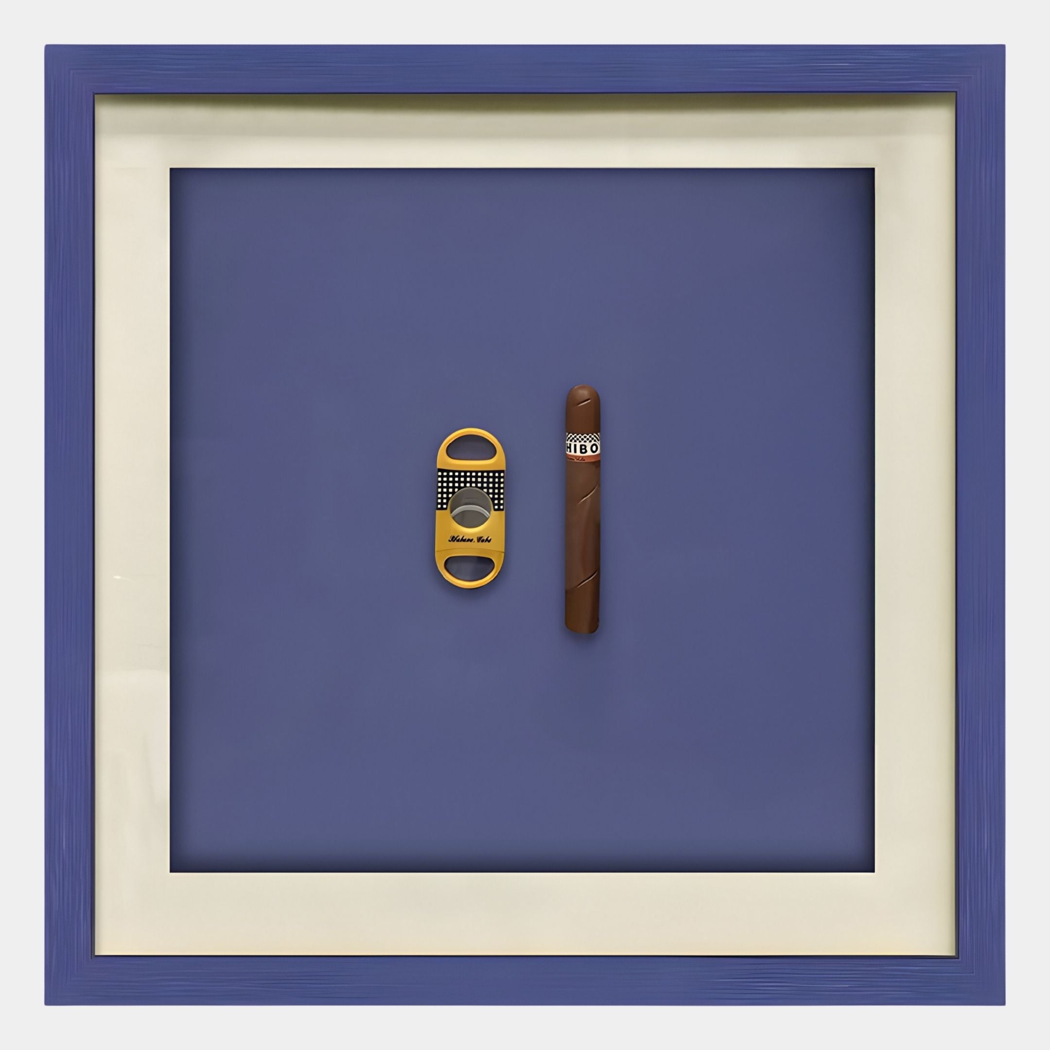 The Cavallero Blue Cigar & Cutter Framed Wall Art by Giant Sculptures showcases a yellow cigar cutter and brown COHIBA cigar on blue with a white mat and blue frame—ideal wall décor for cigar lovers.