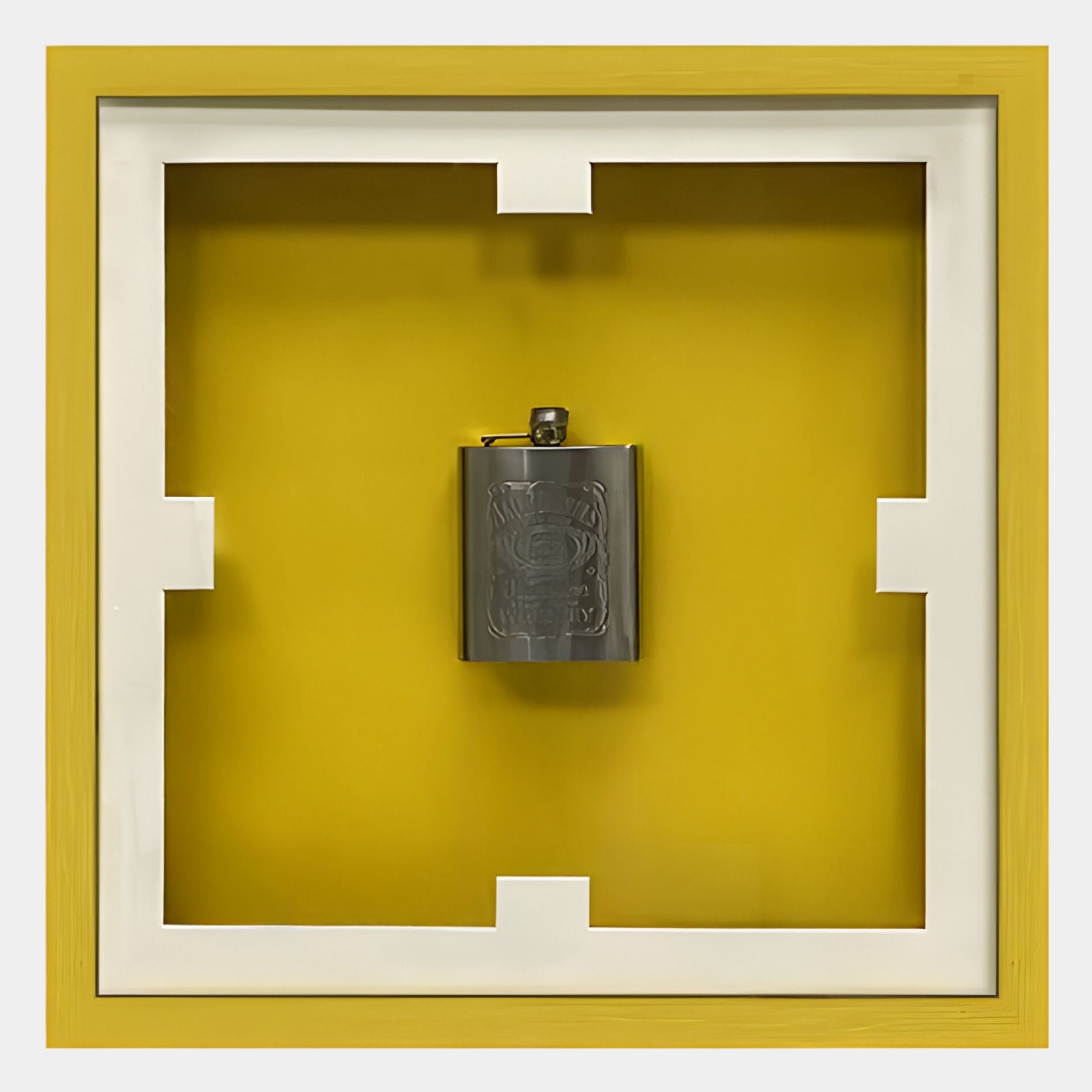 The Cavallero Yellow Hip Flask Display Framed Wall Art by Giant Sculptures features a metal flask centered on a yellow background with a white and yellow geometric border—an eye-catching piece for modern spaces.