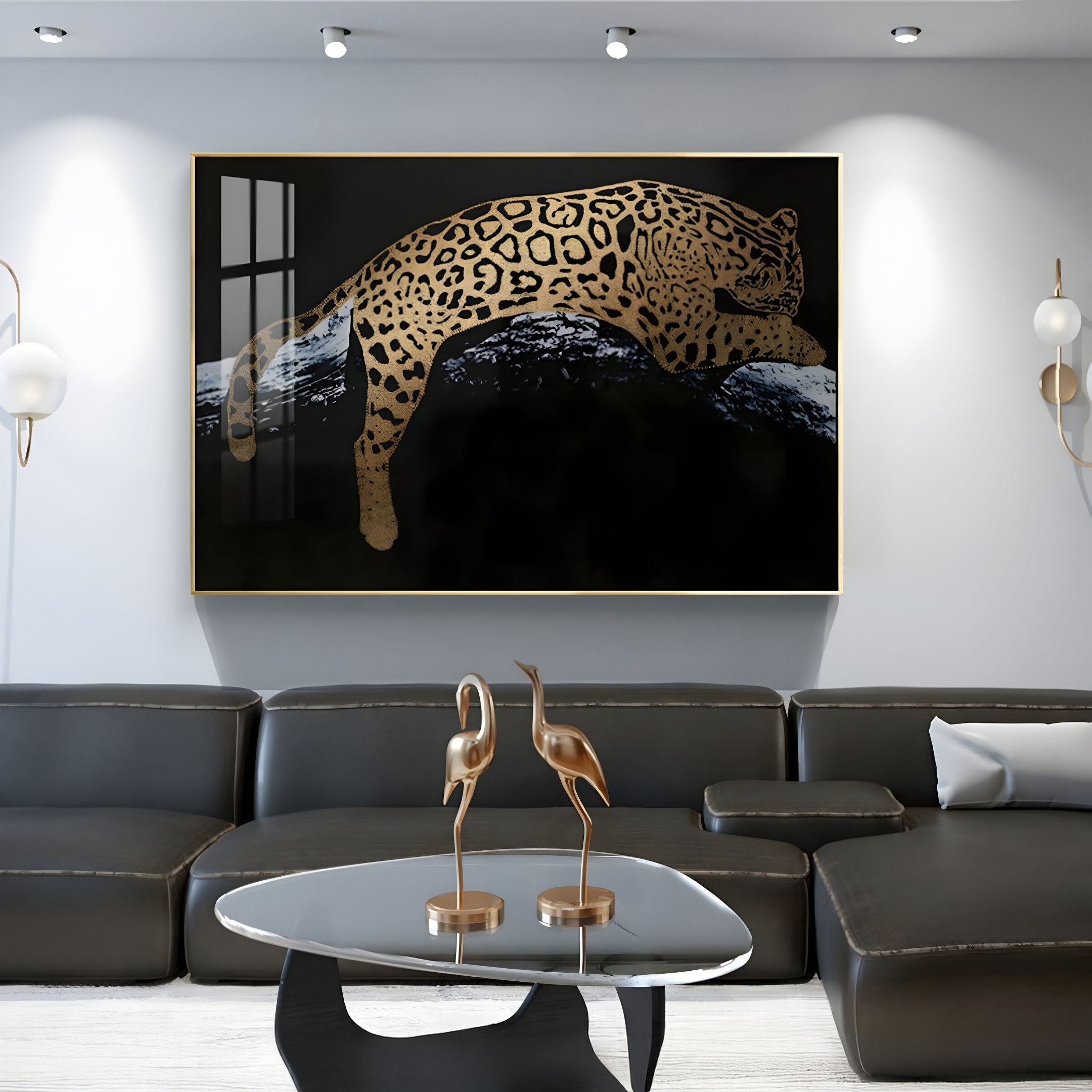 A modern living room featuring a black leather sofa, glass coffee table with two gold crane sculptures, and the Auravalor Gold Leopard Crystal Porcelain 3D Wall Art by Giant Sculptures—luxury decor with a golden leopard leaping over a dark abstract background.