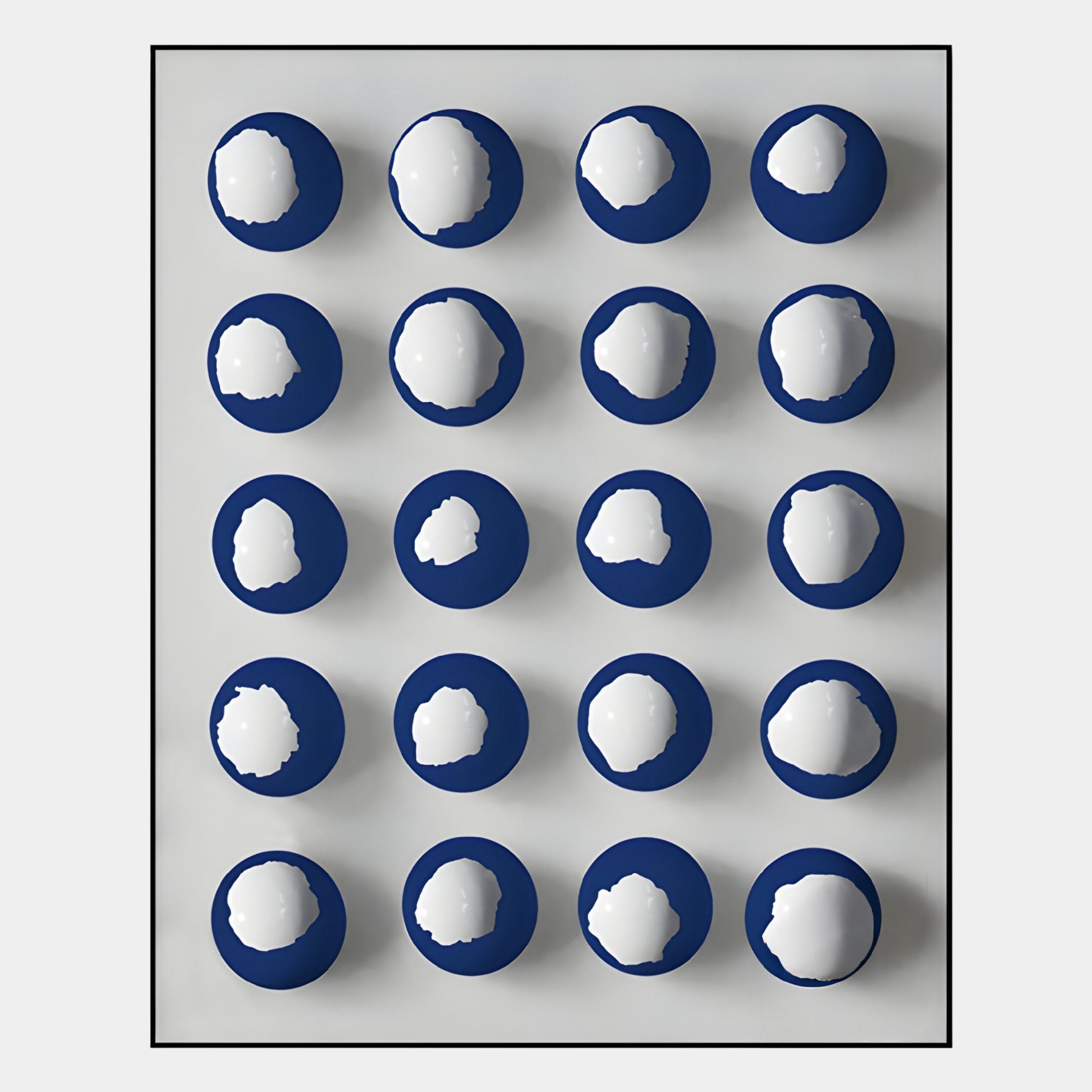 The Orbivelle Blue & White Patch Sphere Panel 3D Wall Art by Giant Sculptures features 20 blue circles with white centers in a four-by-five grid, bordered in black. This modern piece is perfect as a blue and white wall panel for your space.