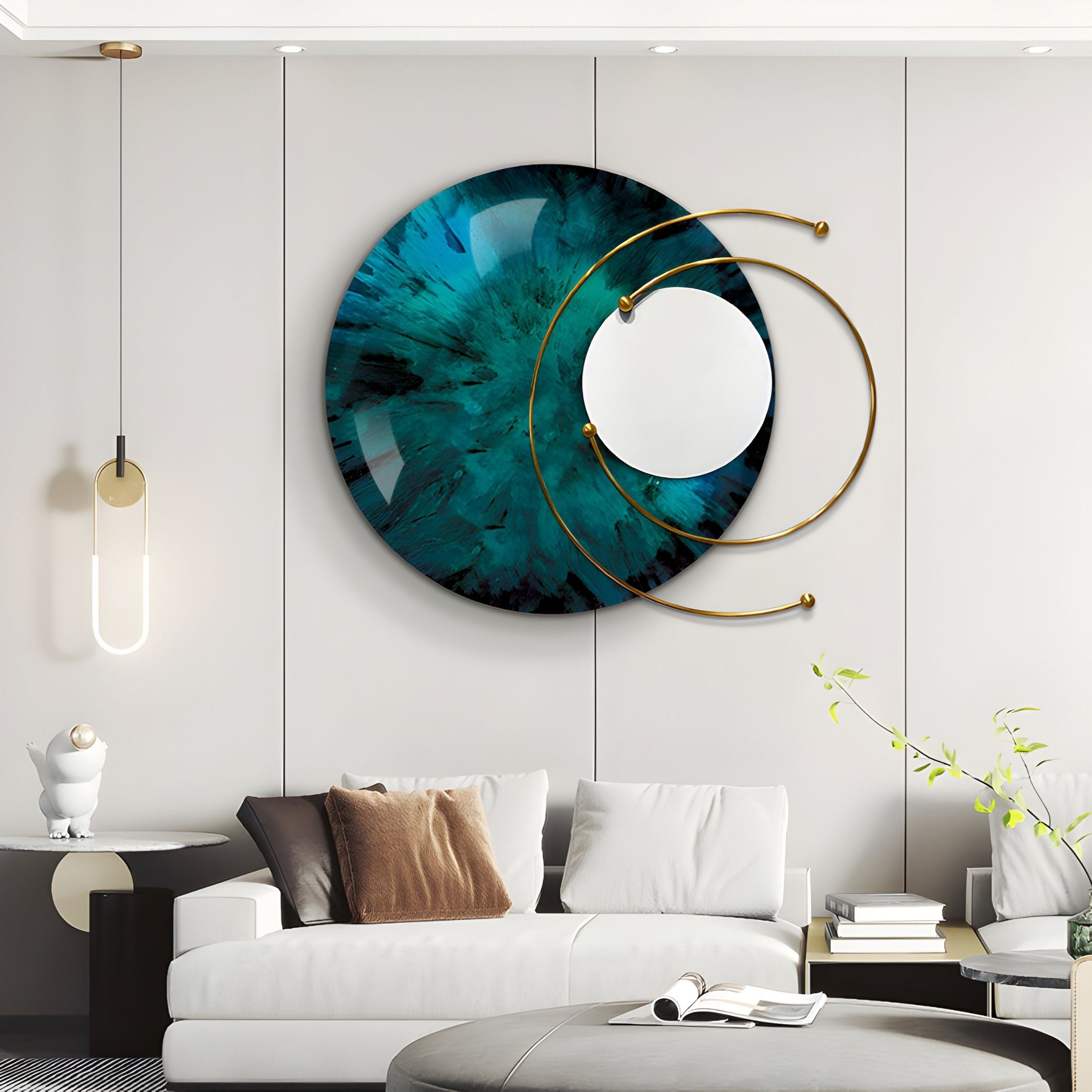 A modern living room features Giant Sculptures’ Aurelios Emerald Crystal Porcelain & Gold Orbit 3D Wall Art above a white sofa with brown and beige cushions, a round coffee table, and minimalist decor.