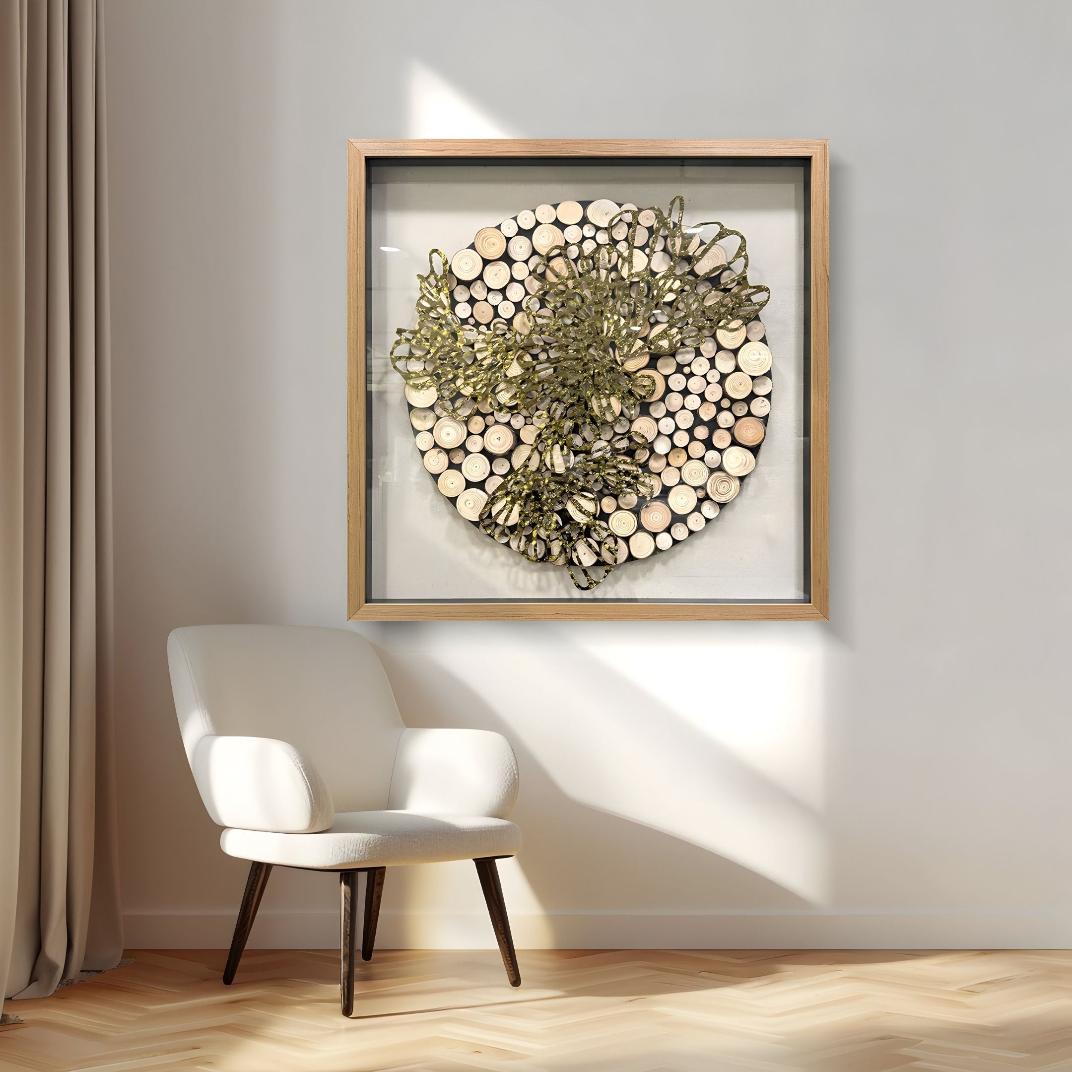 A modern, minimalist room with a white armchair, beige curtains, and the Arborique Radiant Bloom Gold Steel & Wood 3D Wall Art by Giant Sculptures. Sunlight streams in, casting soft shadows on the circular wood and gold metal accent piece.