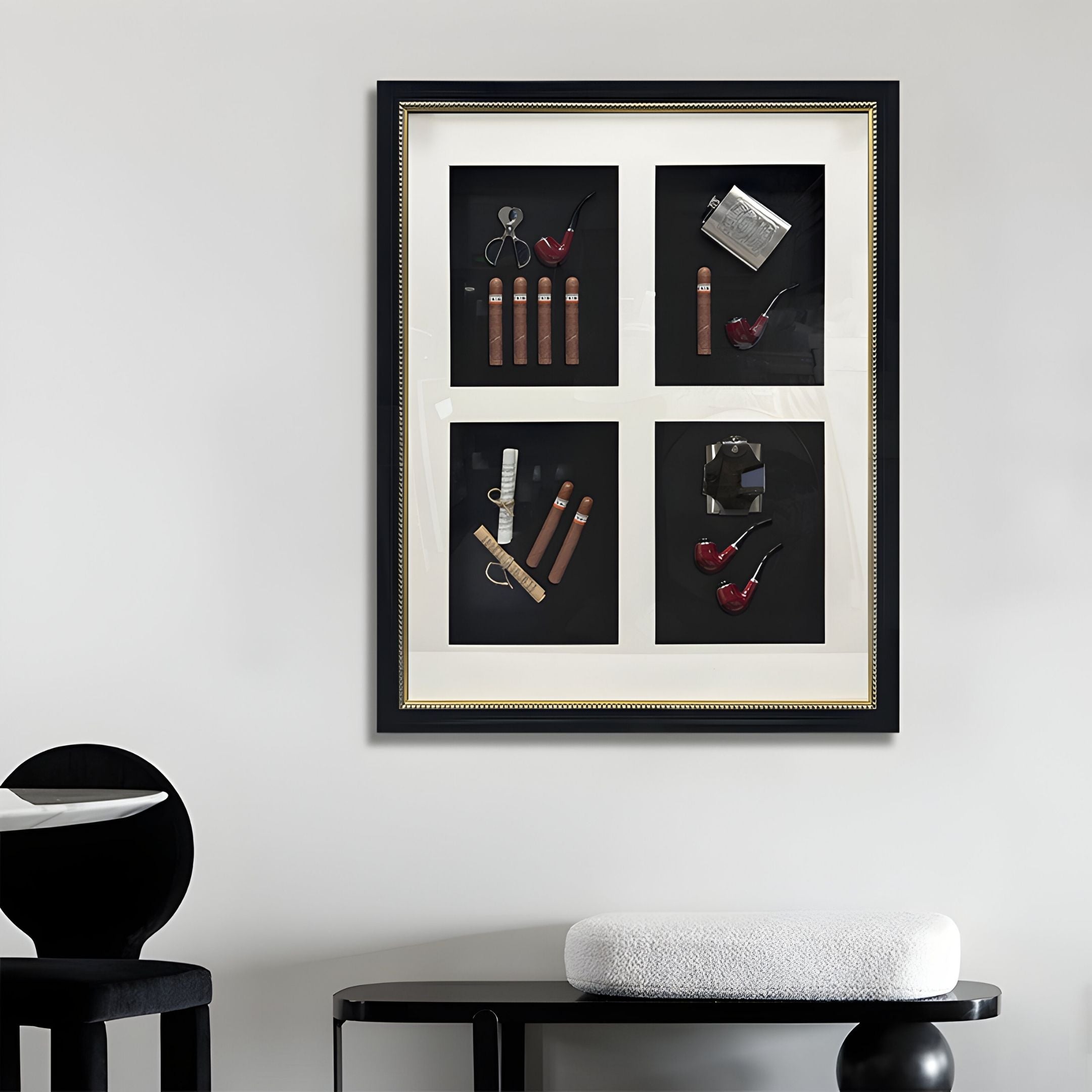 The Cavendrix I Gentleman Cigar Set Curated Framed Wall Art by Giant Sculptures, featuring four sections with pipes and accessories, hangs on a light gray wall above a modern black stool and a round table with a white cushion.